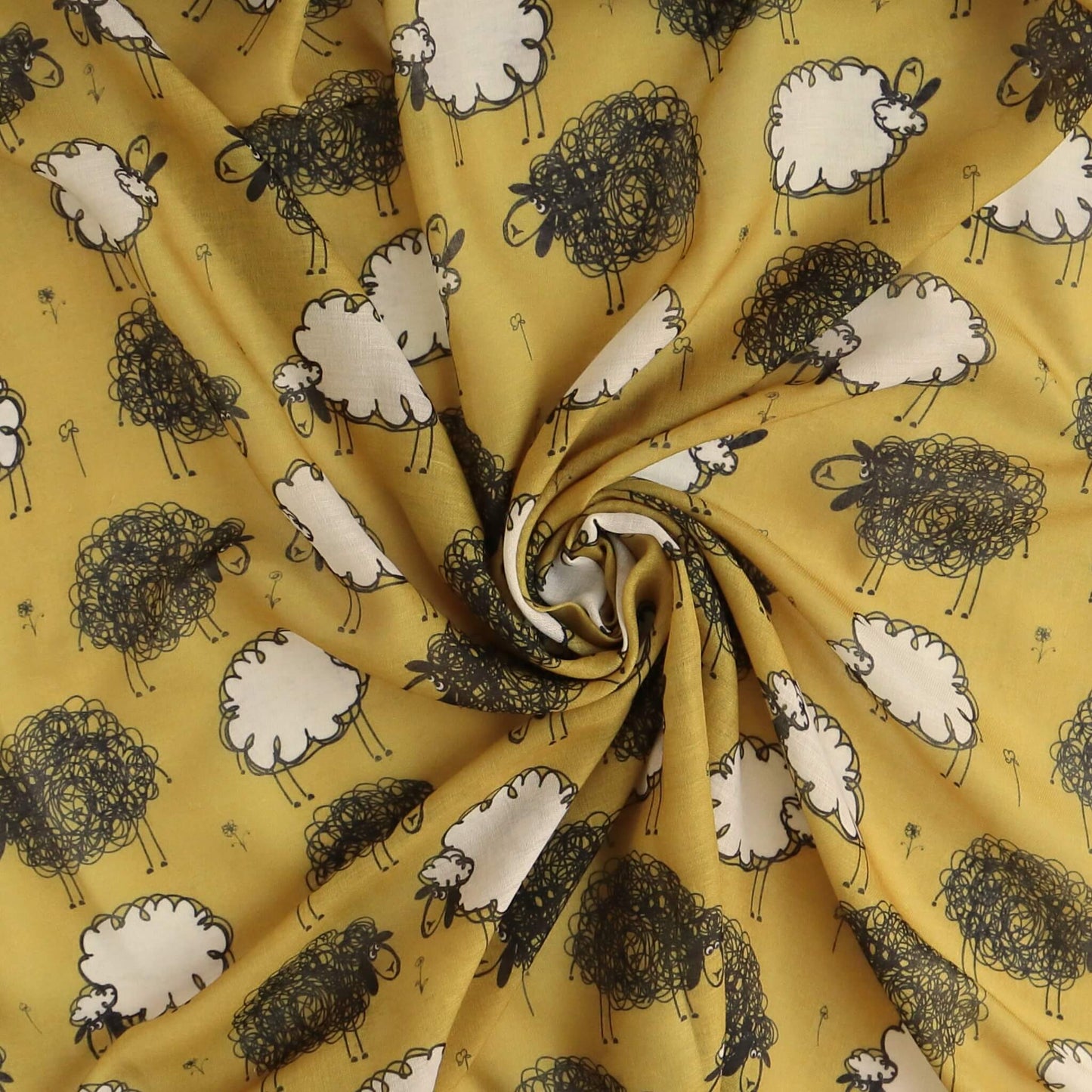 Golden mustard yellow scarf fabric showcasing a charming pattern of black and white sheep. Soft, flowing textile with gentle ripples and folds.