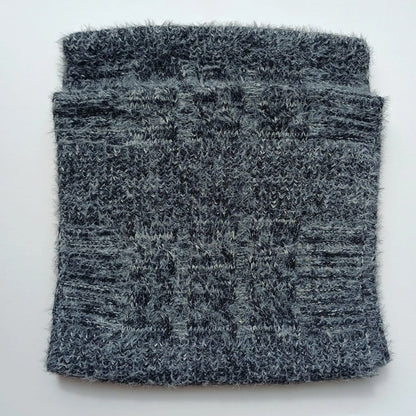 Folded charcoal grey Aran-style knitted snood scarf showing its cable-knit pattern