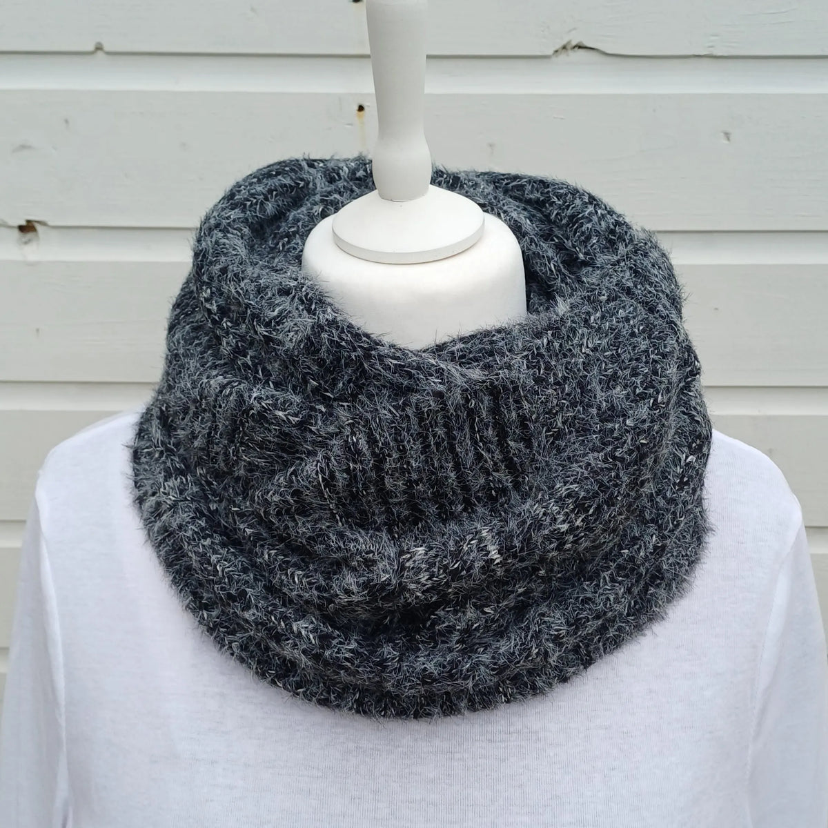 Charcoal grey knitted snood scarf wrapped twice around a mannequin