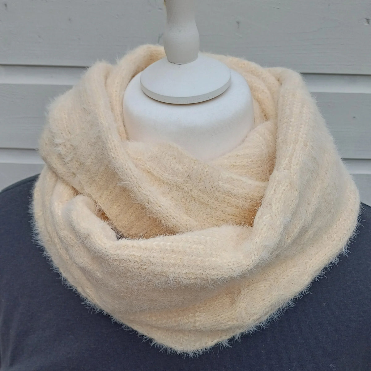 Cream knitted snood scarf wrapped twice around a mannequin