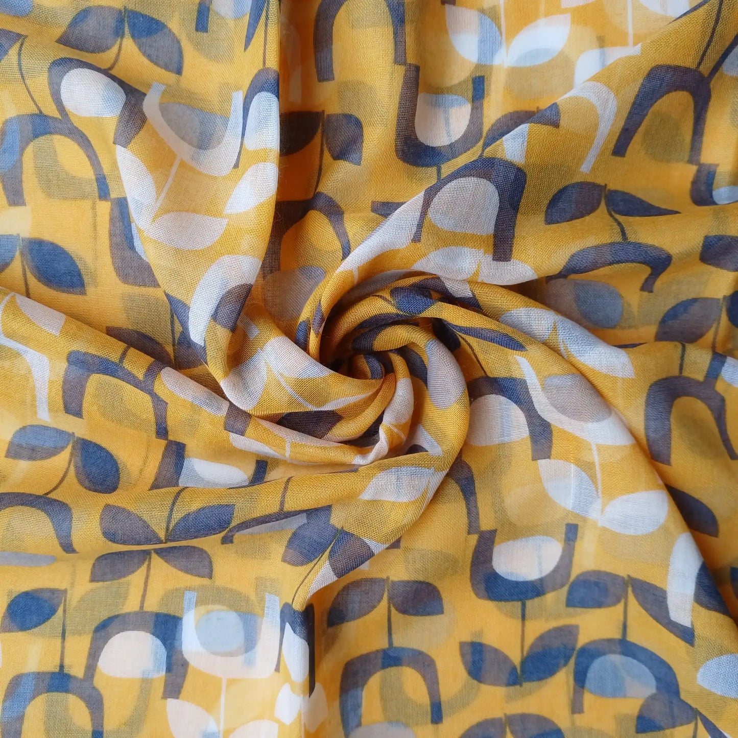 Mustard yellow retro floral scarf styled in swirl fabric flat lay close up