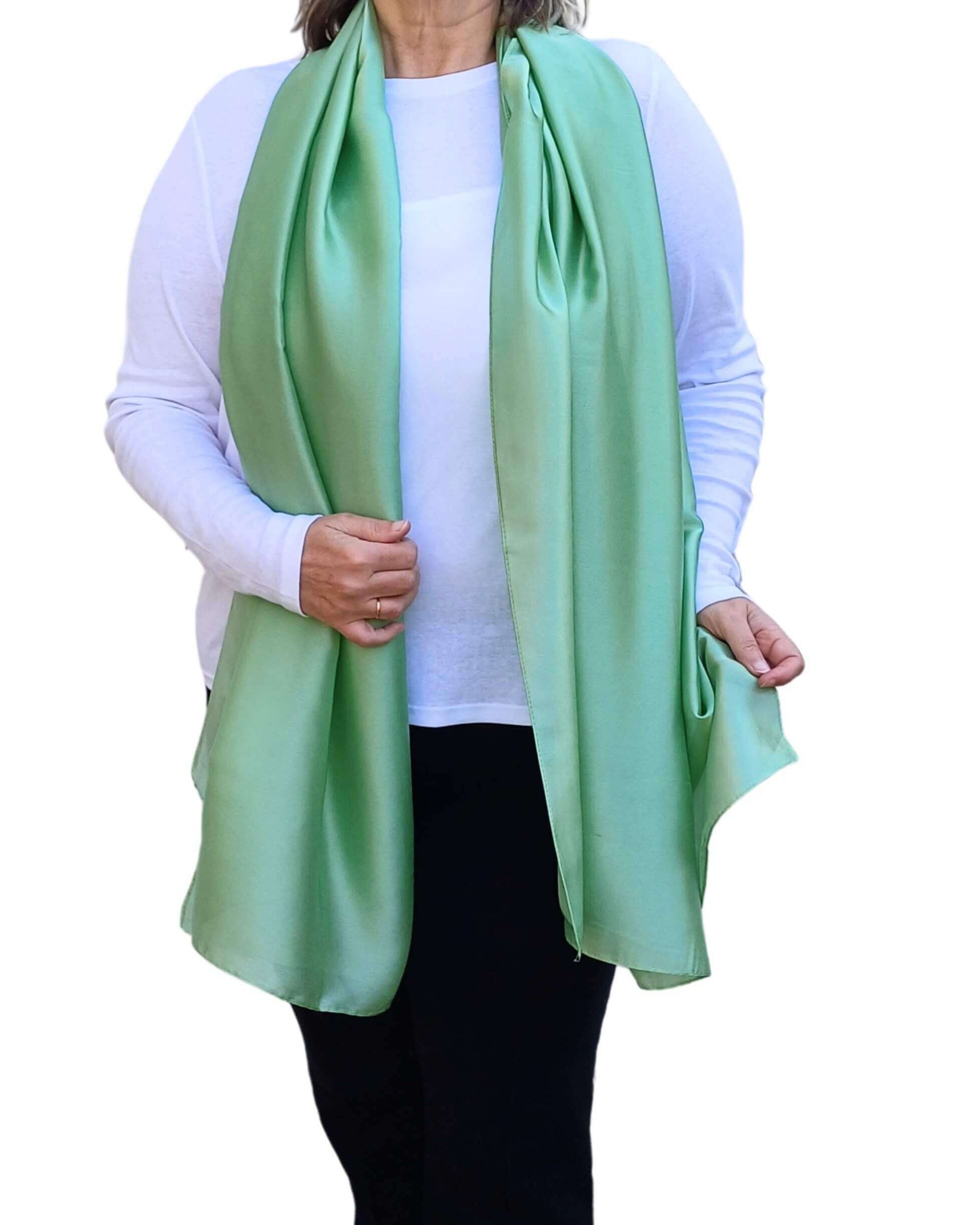 Aurora's Array Elegant Satin Shawl: Woman models a soft, light green silky shawl draped over a white top.