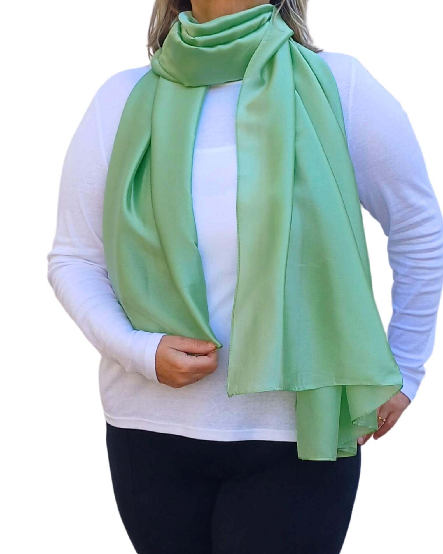 Aurora's Array Elegant Satin Shawl: Woman models a soft, mint green silky shawl draped over a white top.