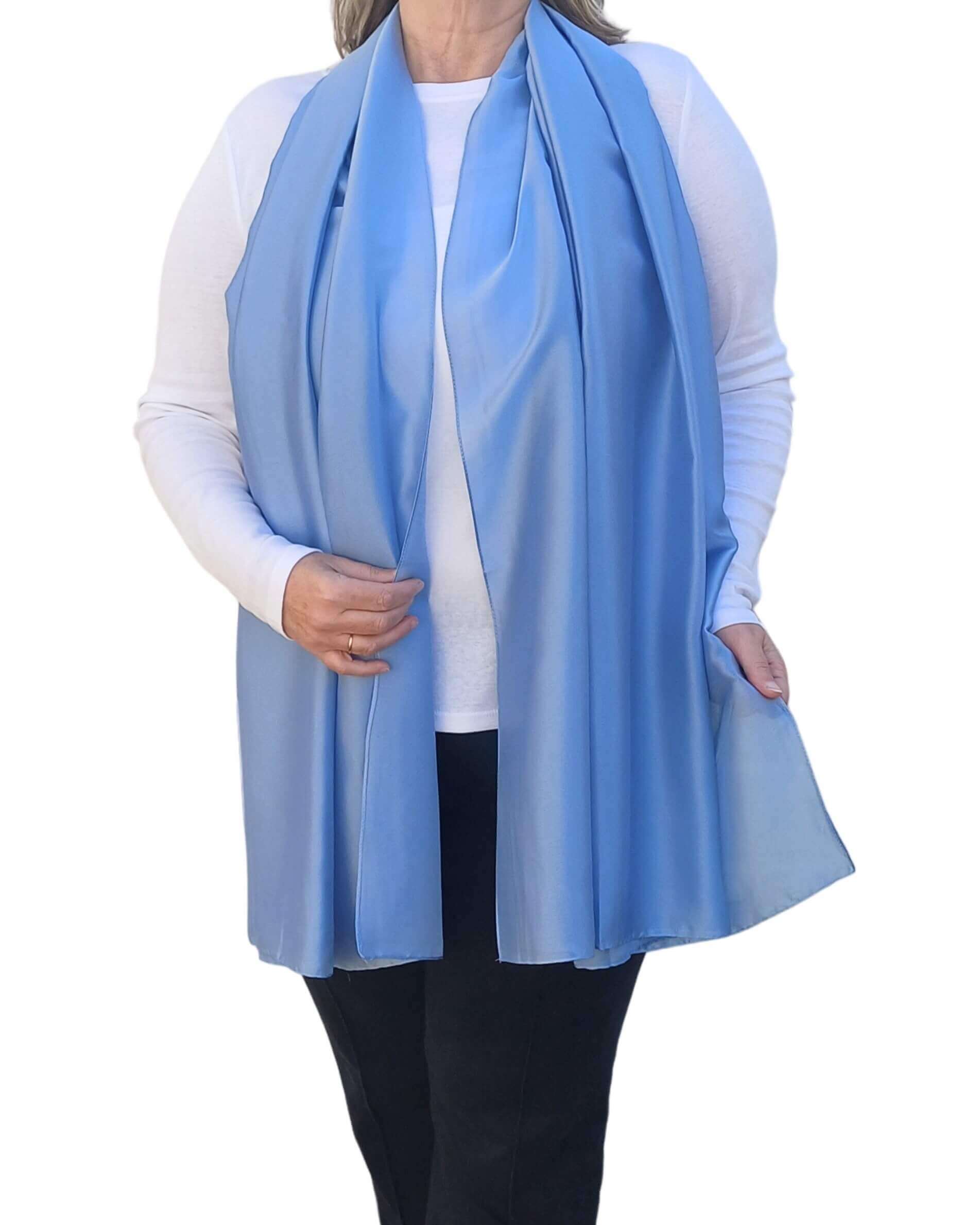 Aurora's Array Elegant Satin Shawl: Woman models a soft, light blue silky shawl draped over a white top.