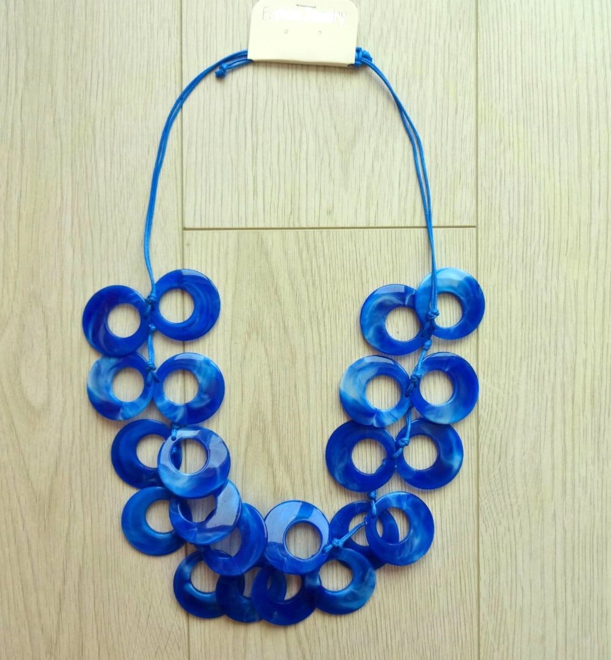 blue-bold-marble-effect-adjustable-length-statement-necklace-flat-lay