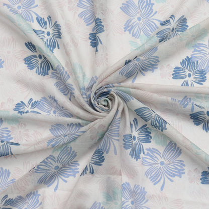 Aurora's Array: Close-up of a lightweight pale grey scarf with a blue floral print, swirled to show detail.