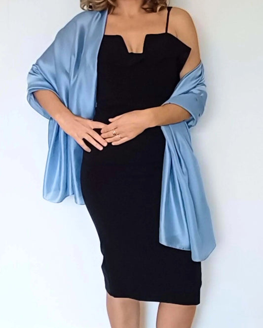 Aurora's Array Elegant Satin Shawl: A woman wearing a fitted black dress has a light blue satin shawl draped over her shoulders.