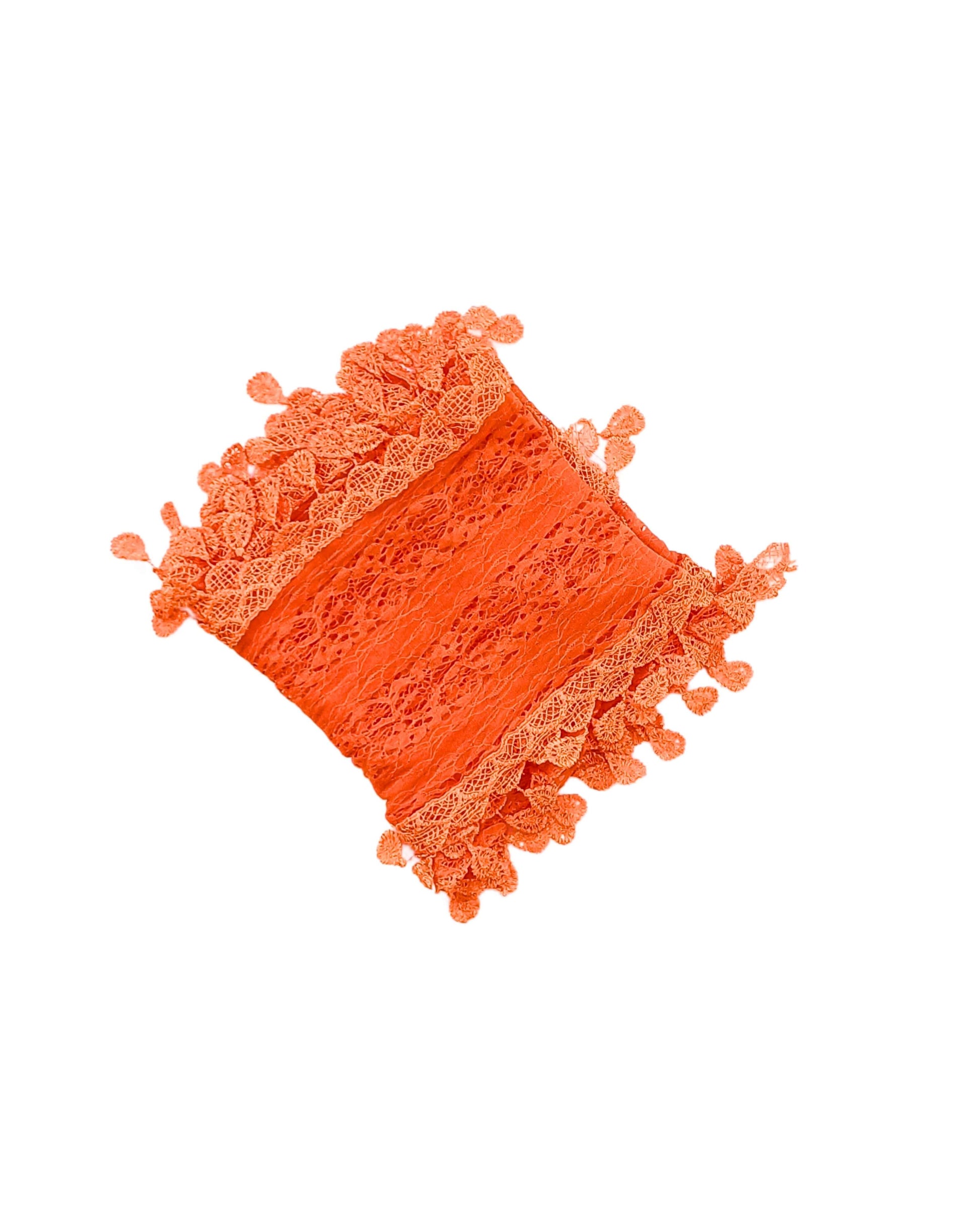Aurora's Array: A vibrant orange lace scarf, folded to show its delicate leaf-like pattern and fringed edges.