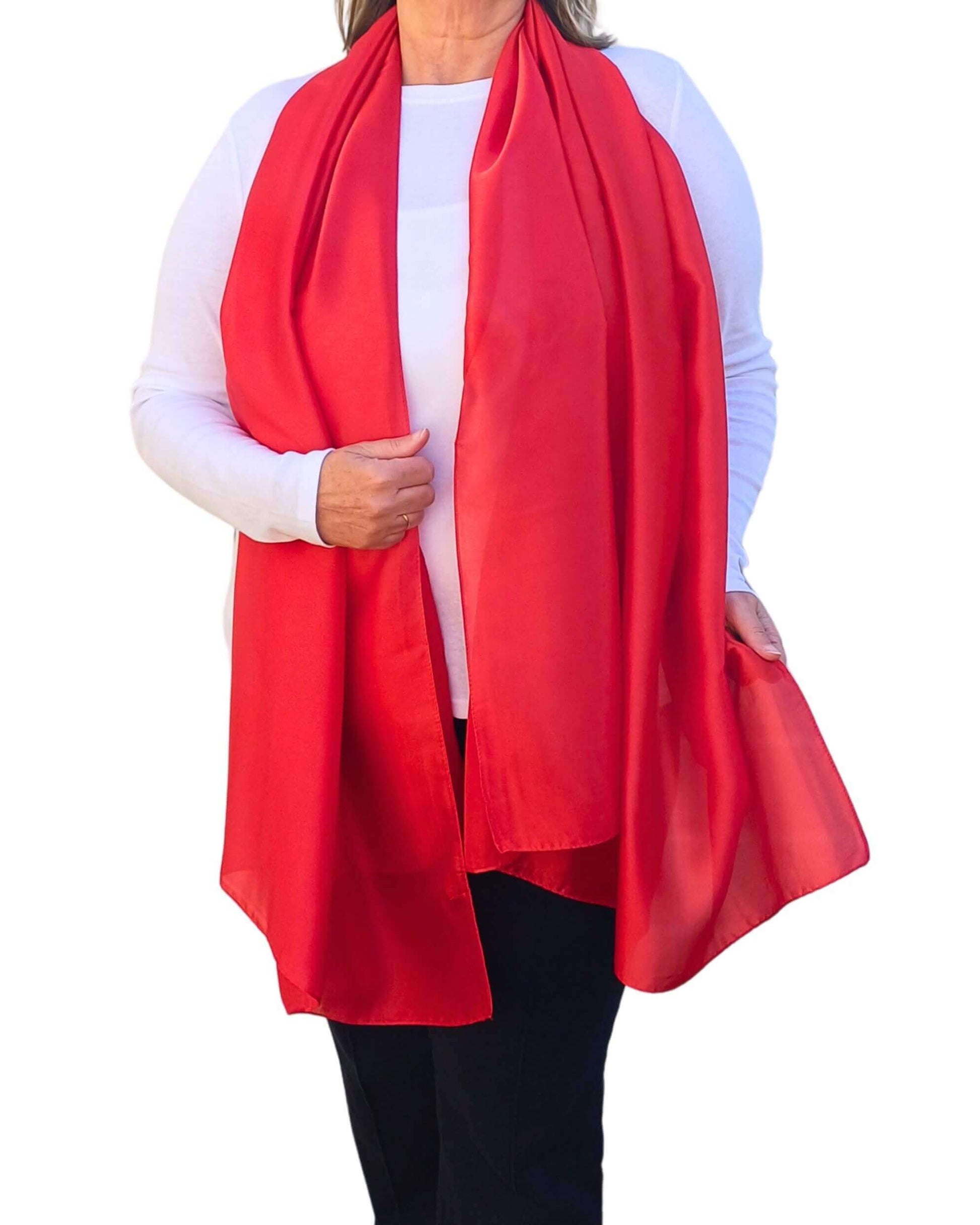 Aurora's Array Elegant Satin Shawl: Woman models a soft, vibrant red silky shawl draped over a white top.