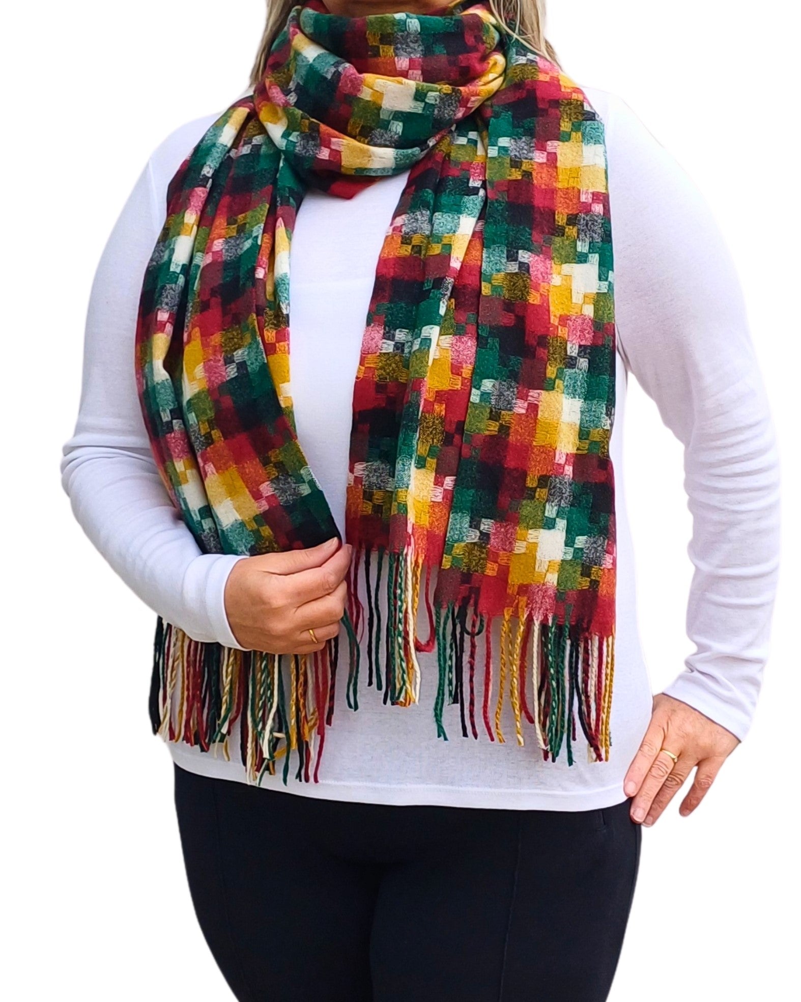 Aurora's Array: Woman models a soft, patterned winter scarf in shades of red, green, yellow, and cream with fringed edges, wrapped around her neck.