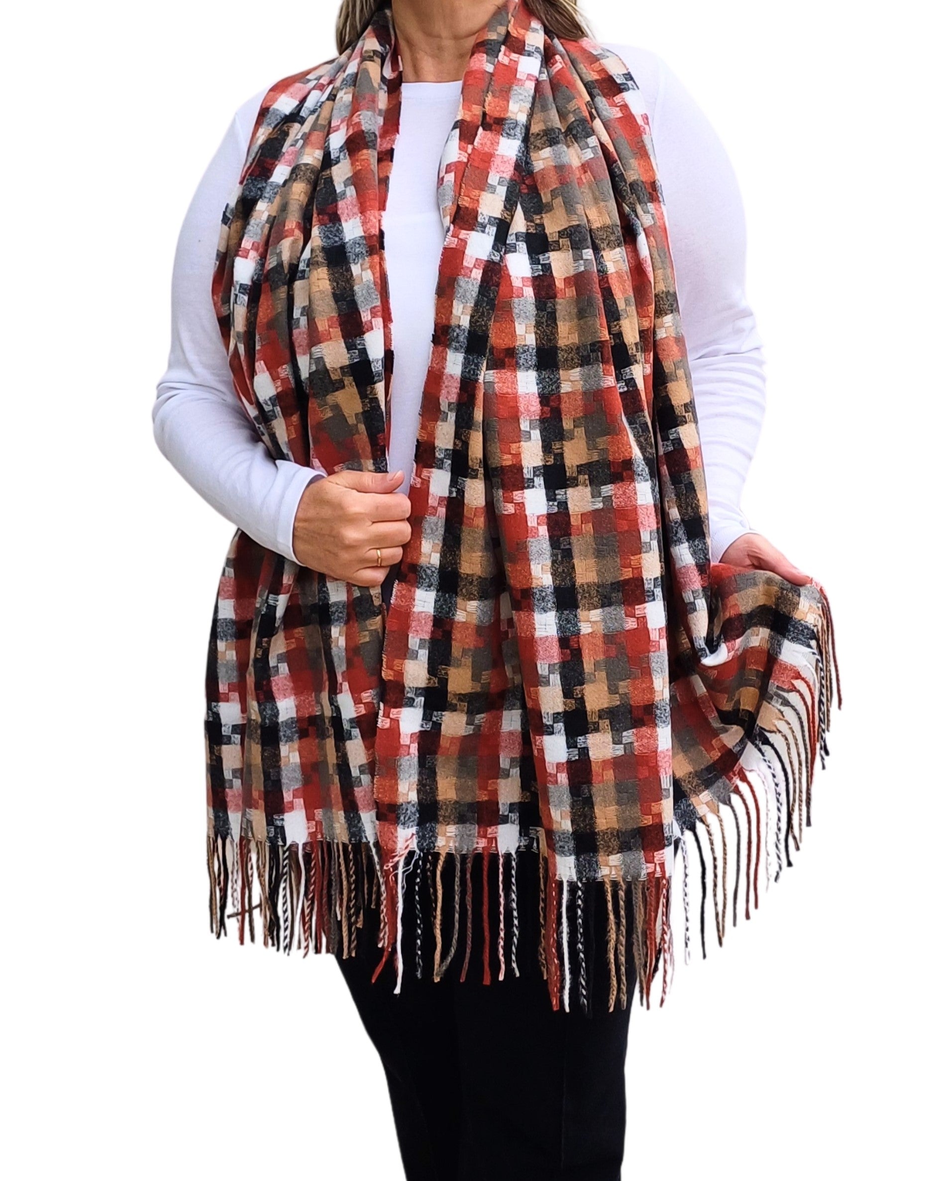 Aurora's Array: Woman models a soft, oversized plaid scarf in shades of rust, brown, black, and cream with fringed edges.