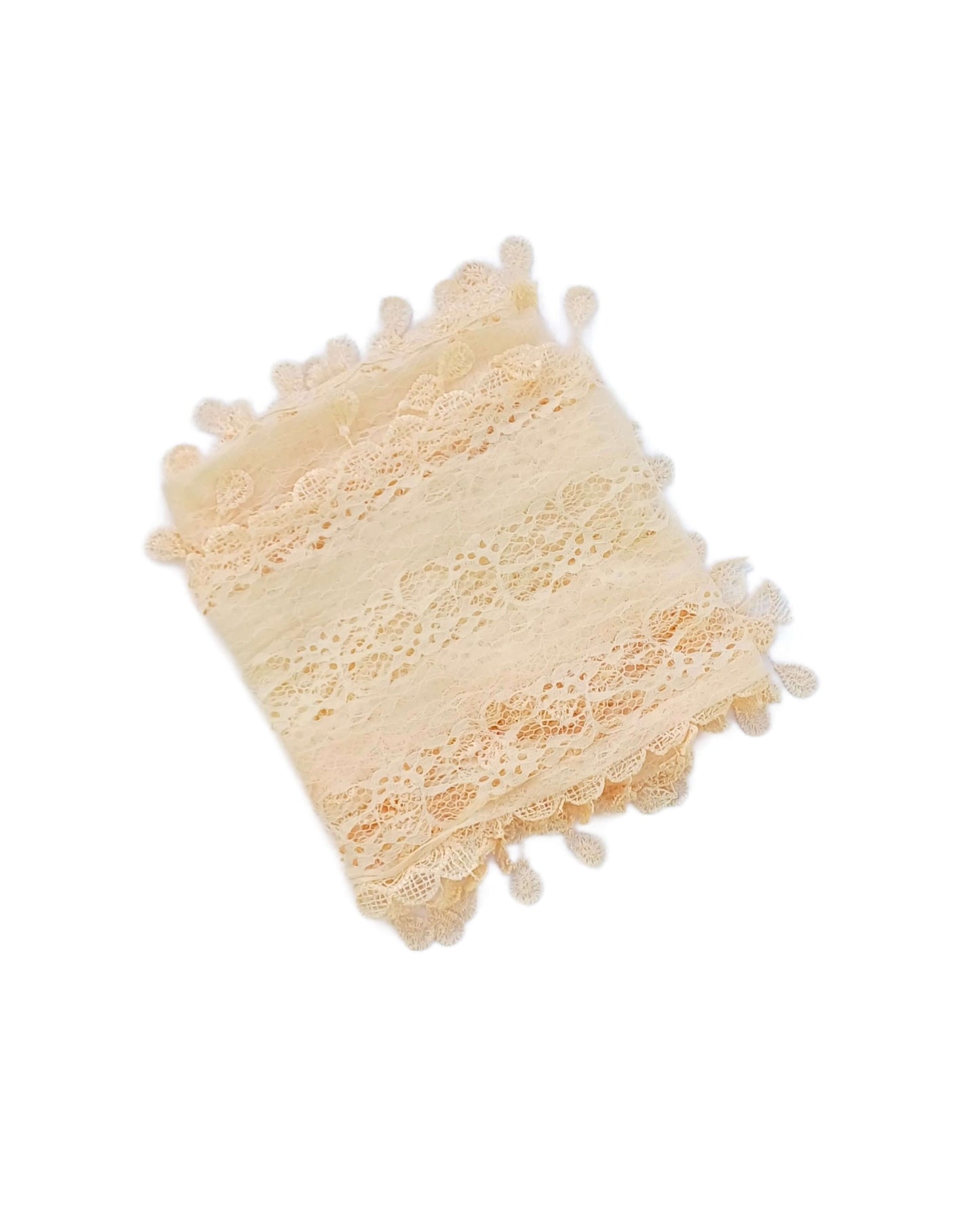 Aurora's Array: A soft cream-coloured lace scarf, folded to show its delicate leaf-like pattern and fringed edges.
