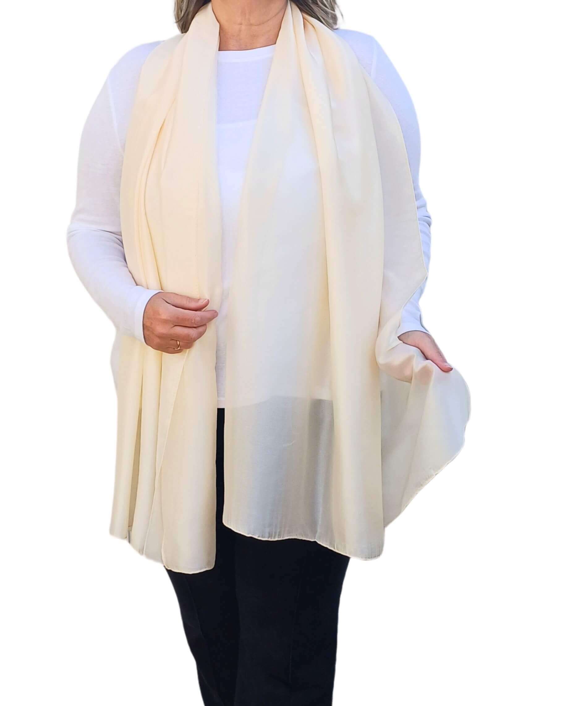 Aurora's Array Elegant Satin Shawl: Woman models a soft, ivory cream silky shawl draped over a white top.