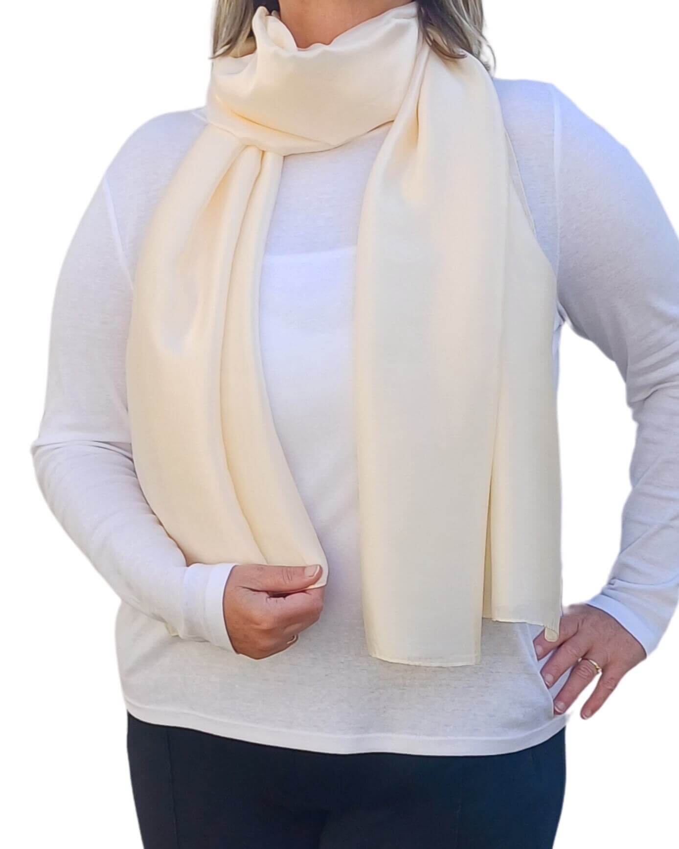  Aurora's Array Elegant Satin Shawl: Woman models a soft, ivory cream silky scarf wrapped around her neck over a white top.