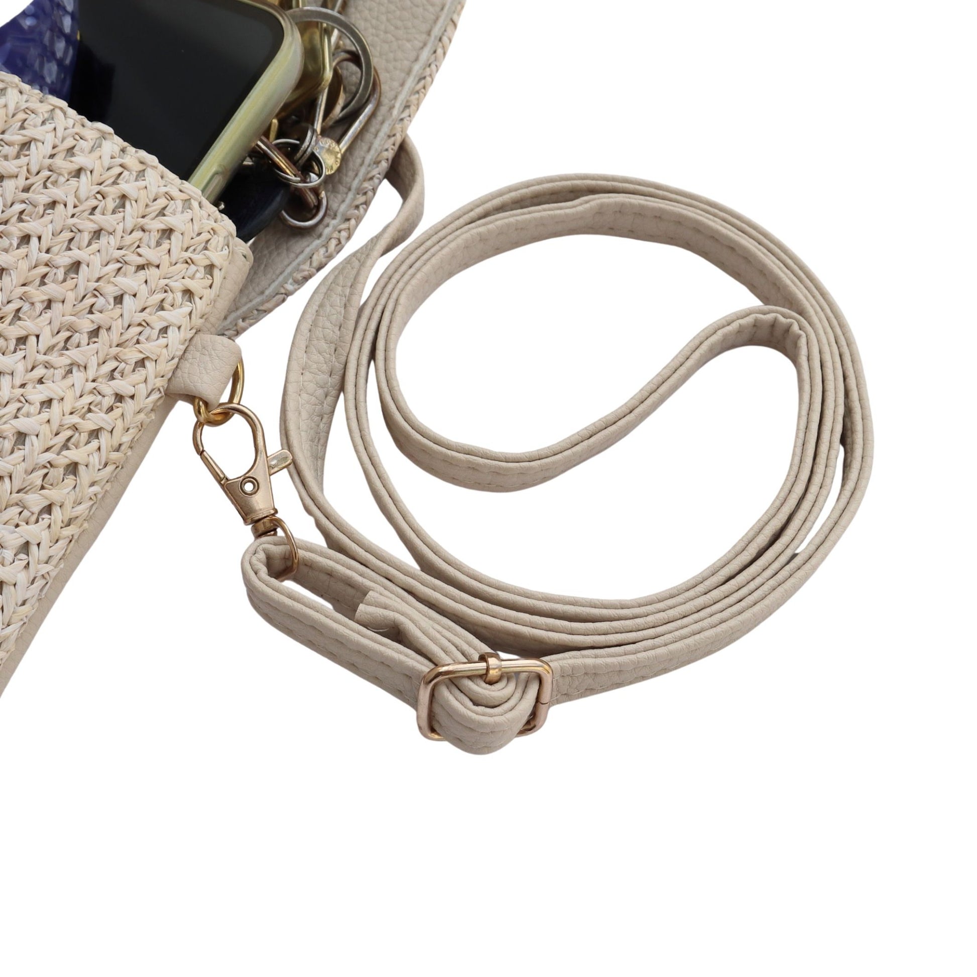 Aurora's Array: Close-up detail of a beige woven crossbody phone bag showing the adjustable strap, gold-toned hardware, and a glimpse of items inside.