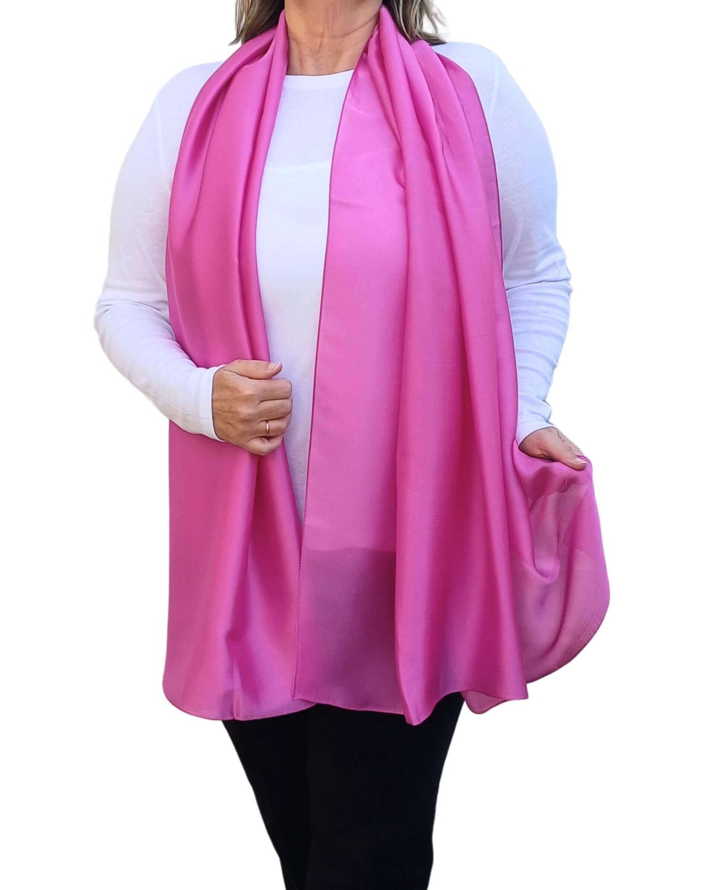 Aurora's Array Elegant Satin Shawl: Woman models a soft, bright pink silky shawl draped over a white top.
