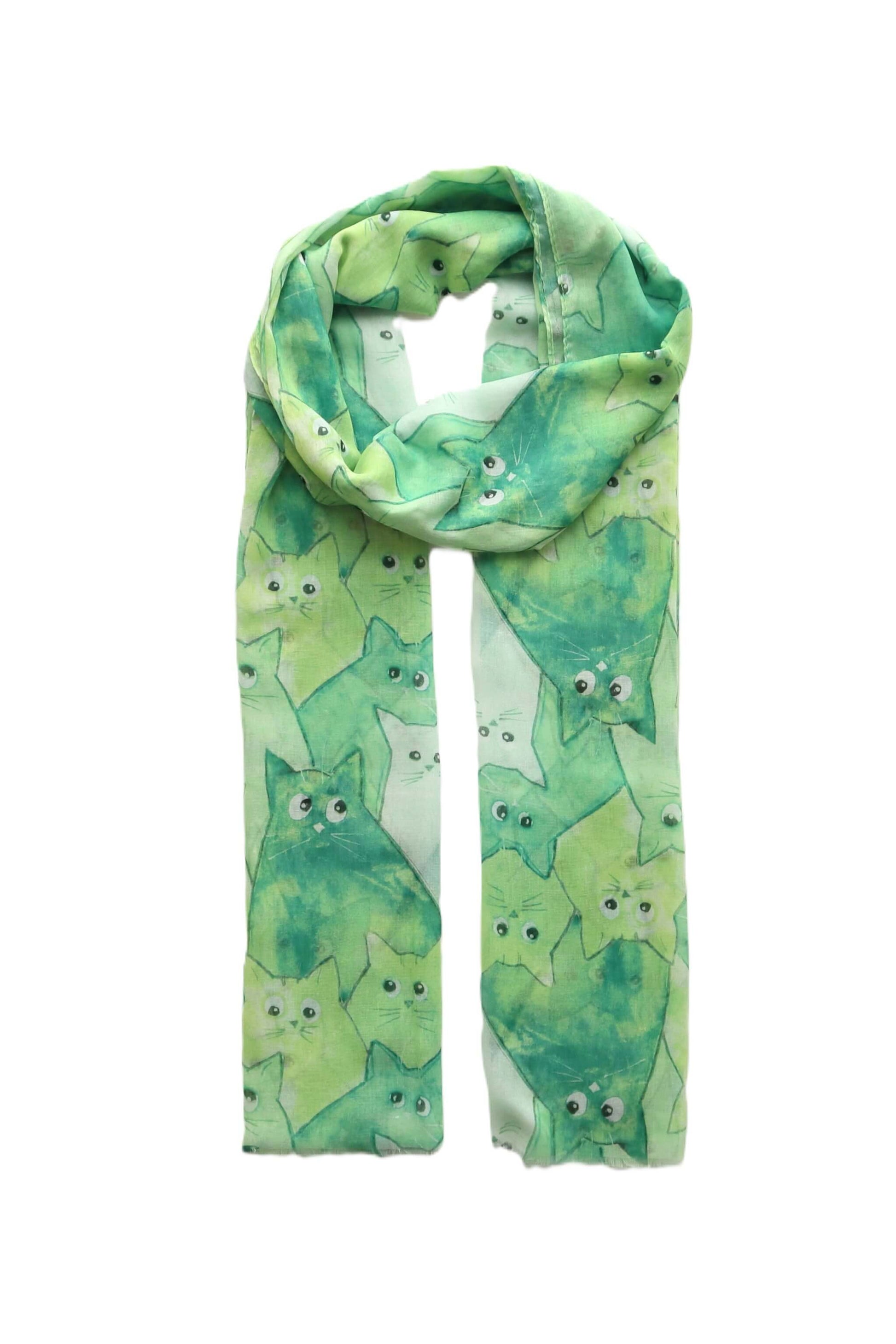 Lightweight green scarf with a fun cartoon cat pattern in various green and white hues. Stylish and soft accessory.