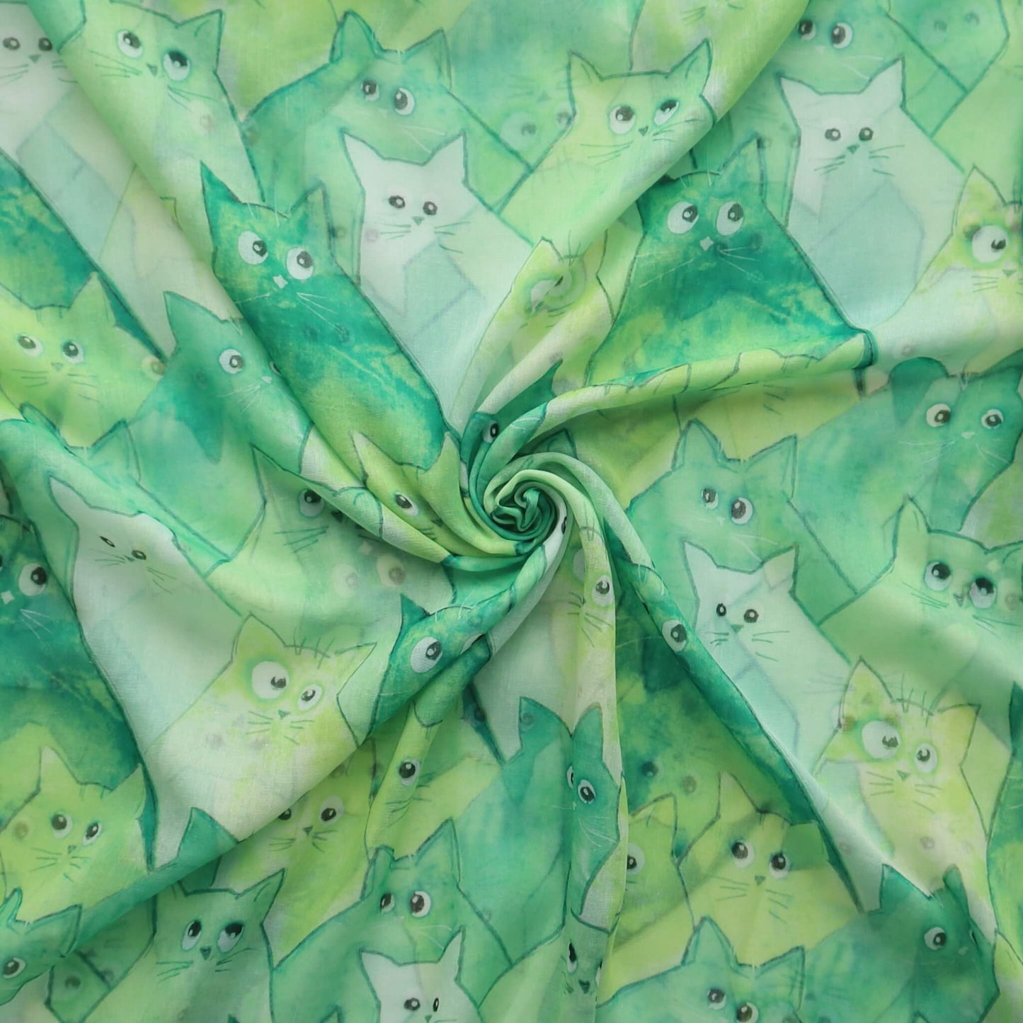 Green scarf fabric with a cute cartoon cat print in shades of green and white. Soft, lightweight textile.