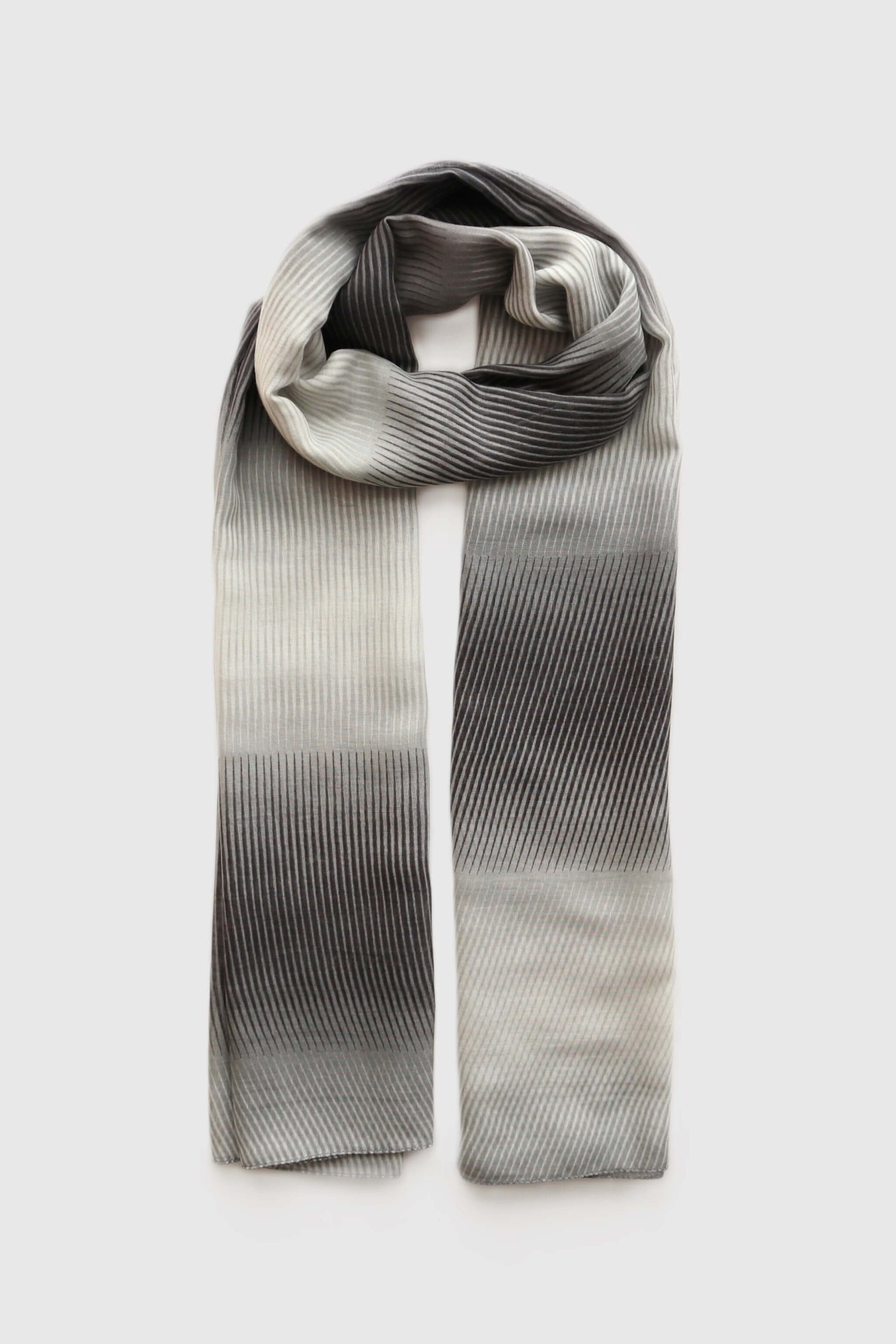 Textured scarf with a flowing stripe design and a subtle gradient of dark grey fading into a lighter silver hue.
