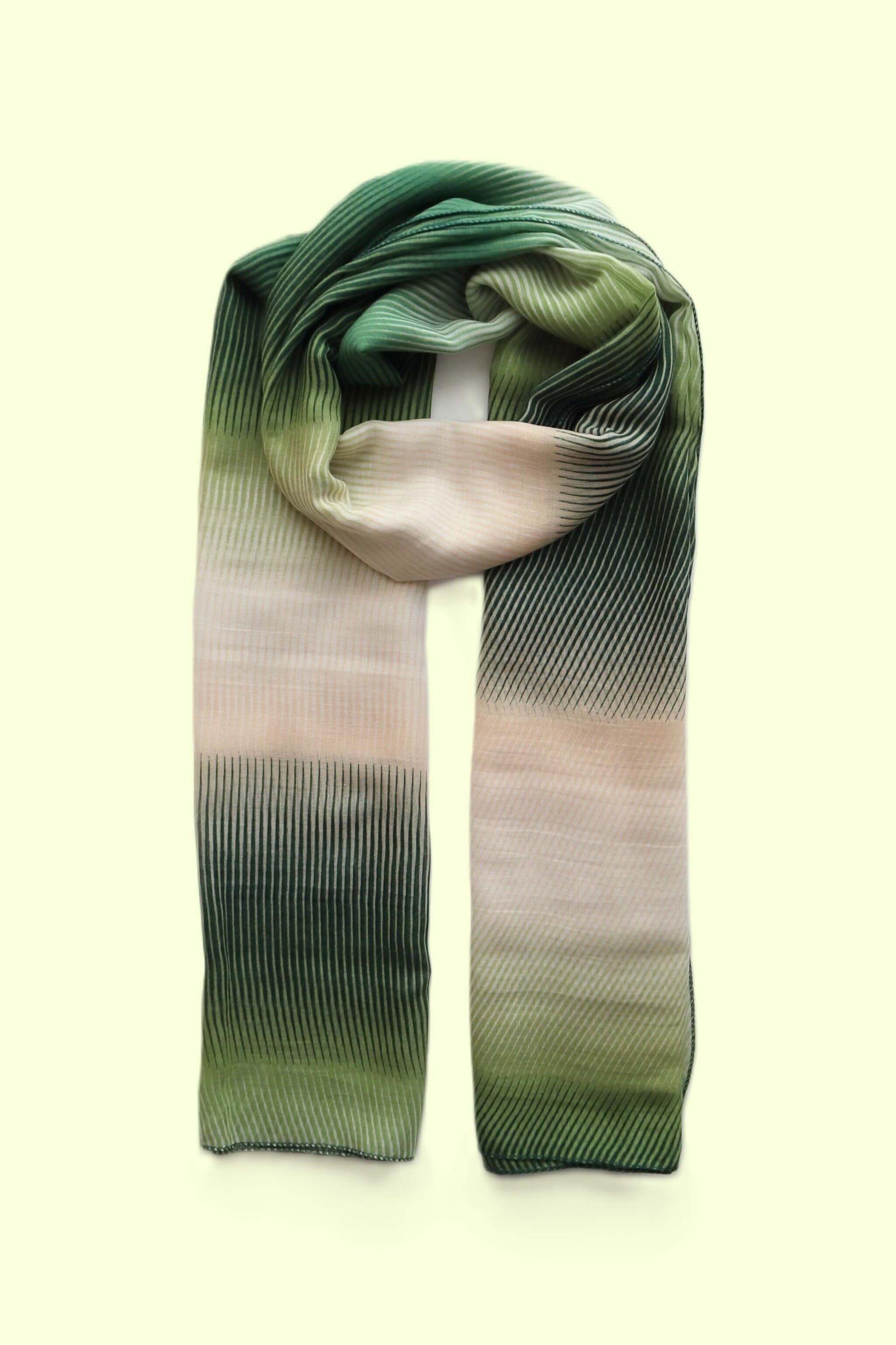 Softly textured scarf with a flowing stripe pattern and a subtle ombre effect transitioning from deep green to light cream.