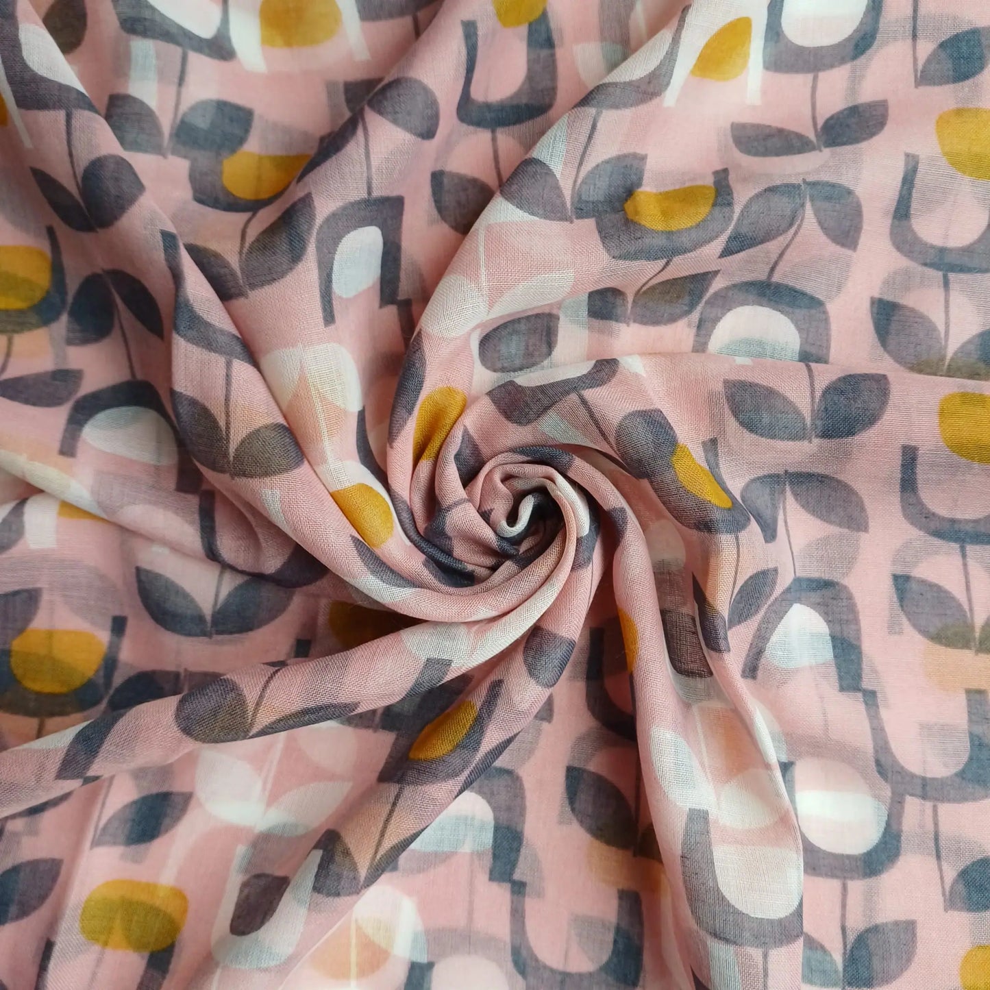 Dusky pink abstract floral scarf styled in spiral fabric close up