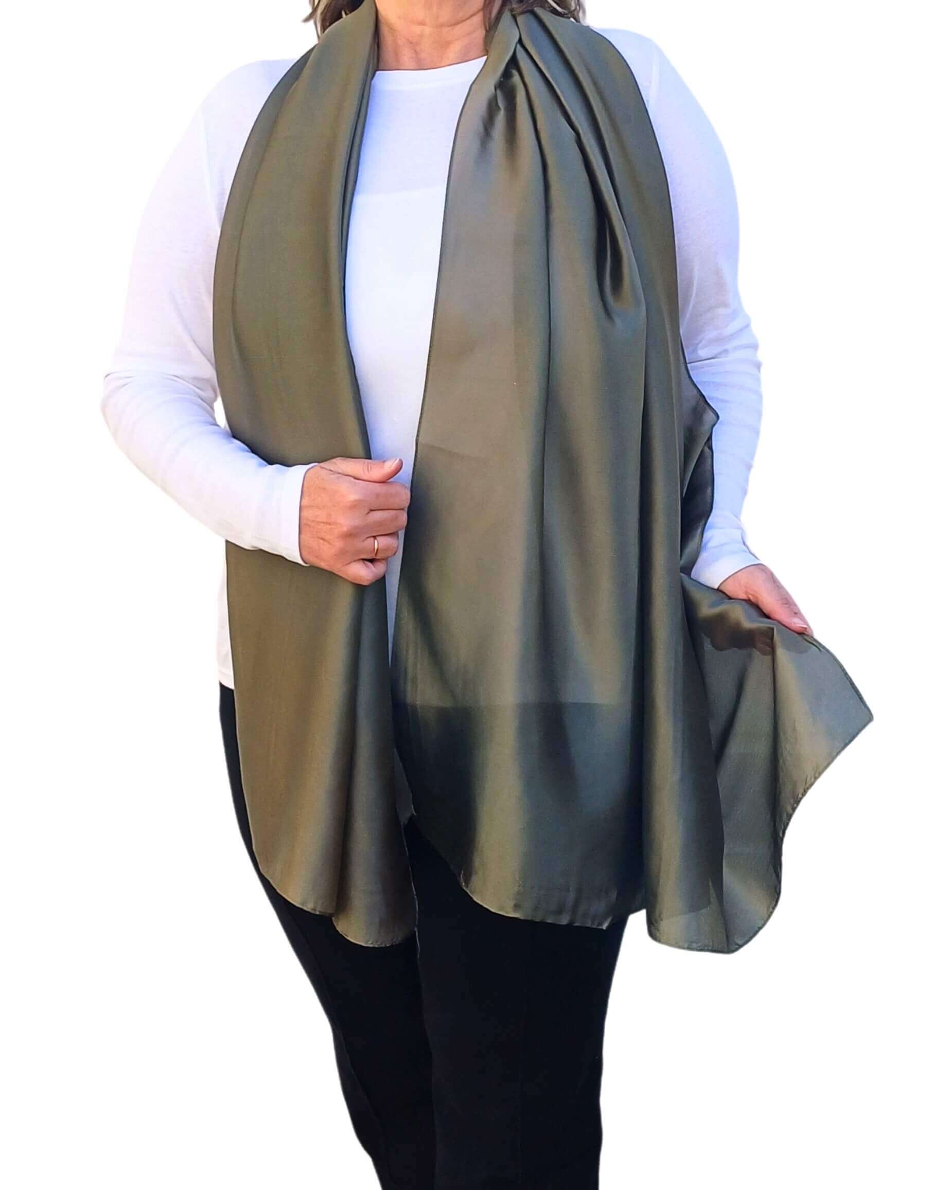 Aurora's Array Elegant Satin Shawl: Woman models a soft, khaki green silky shawl draped over a white top.