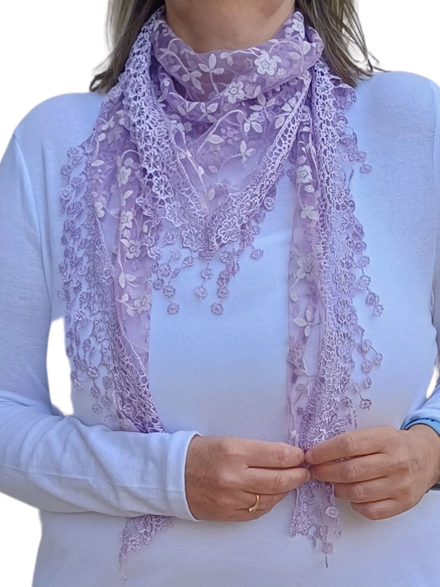 Aurora's Array Glitter Triangle Scarf with Lace & Embroidery: A woman models a lilac, sheer triangle scarf with a delicate white floral print, intricate lace trim, and dangling embroidered accents.