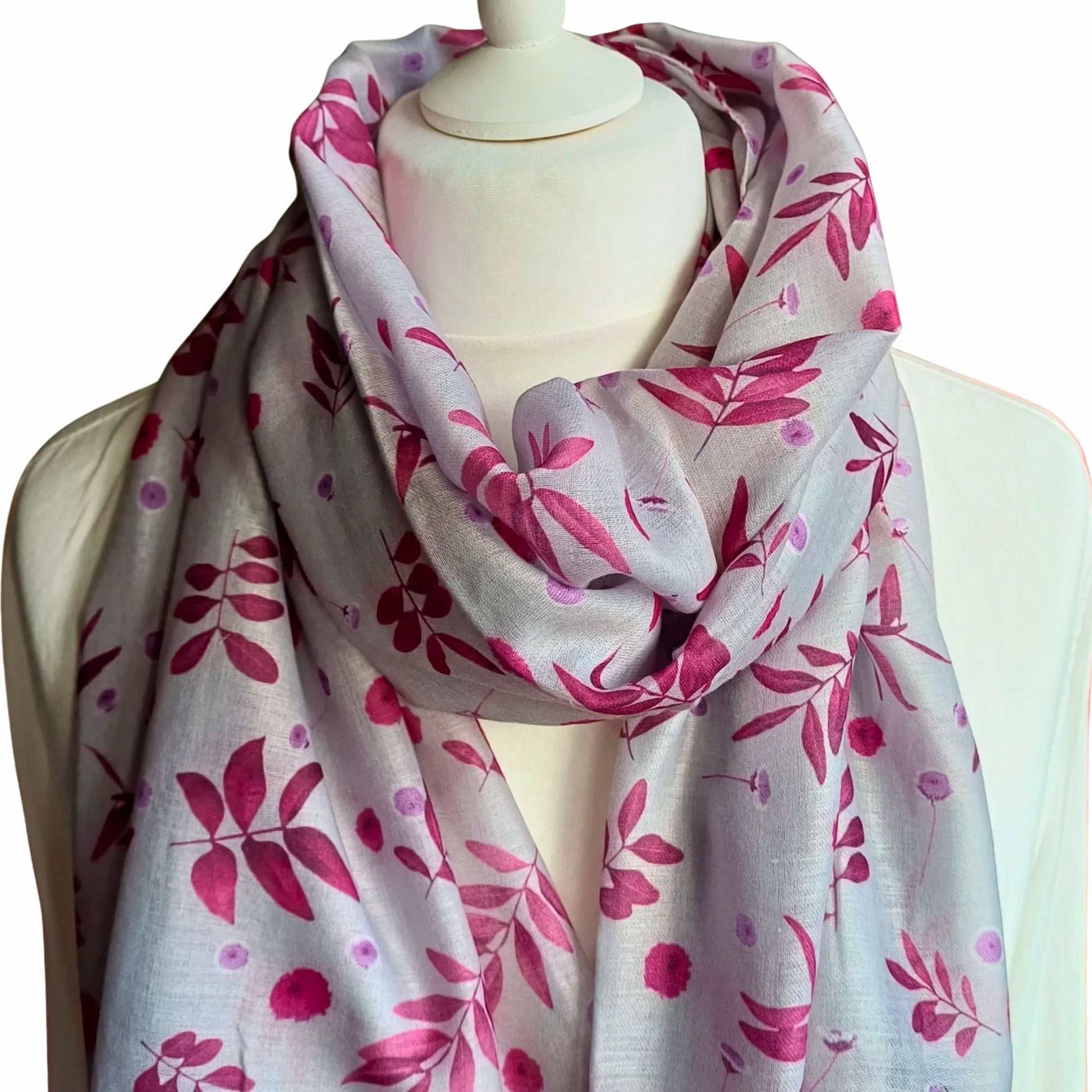 Pink Floral patterned scarf on a mannequin against a white background