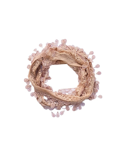 Aurora's Array: A soft nude beige scarf made of delicate lace with a leaf-like pattern and fringed edges, forming a circular shape.