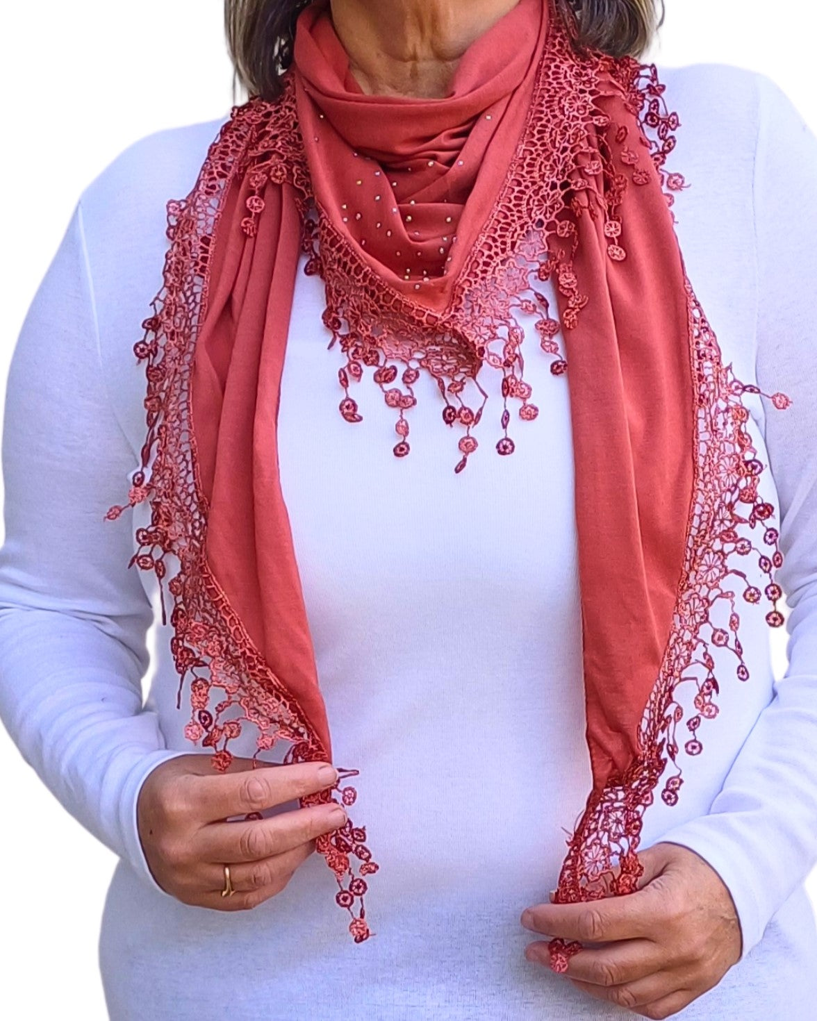 Aurora's Array: Model wearing a rust-orange lightweight triangle scarf with lace trim and subtle sparkles, styled over a white top.