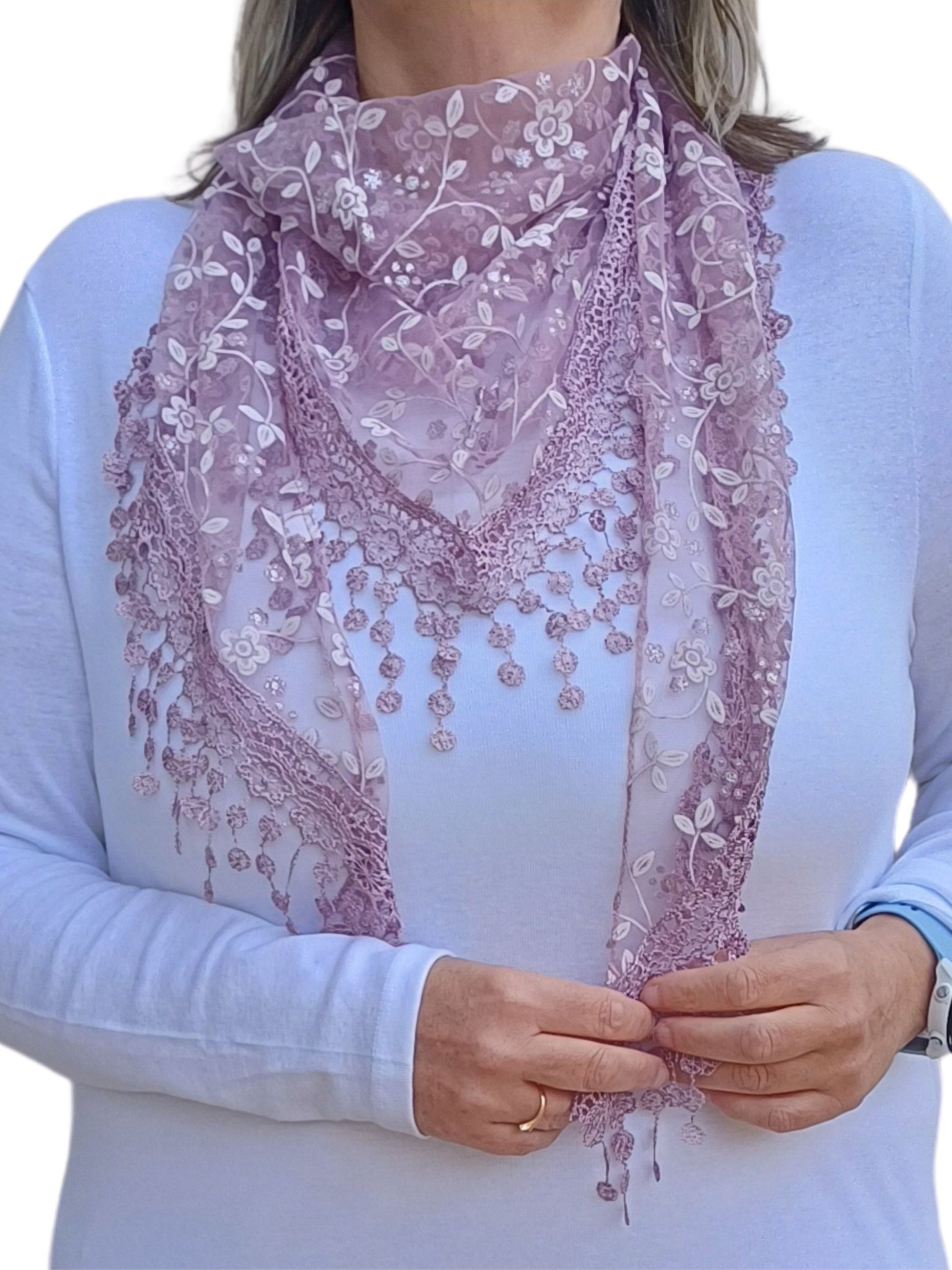 Aurora's Array Glitter Triangle Scarf with Lace & Embroidery: A woman models a light purple, sheer triangle scarf with a delicate white floral print, intricate lace trim, and dangling embroidered accents.