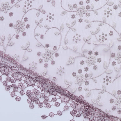 Aurora's Array Glitter Triangle Scarf with Lace & Embroidery (Close-up): A detailed close-up of a light purple, sheer fabric with delicate white floral embroidery accented with subtle glitter. The edge features intricate light purple lace trim with dangli