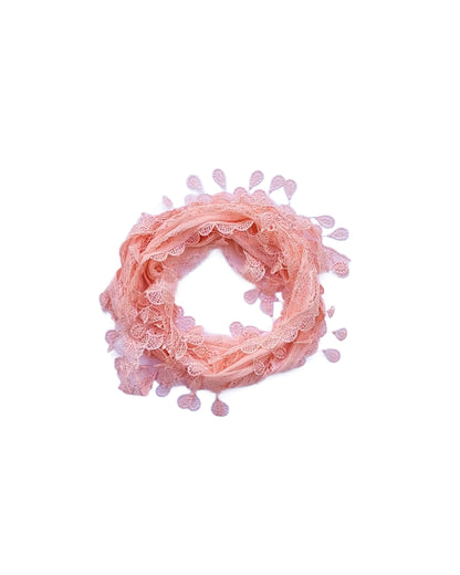 Aurora's Array: A soft peach-coloured scarf made of delicate lace with a leaf-like pattern and fringed edges, forming a circular shape.