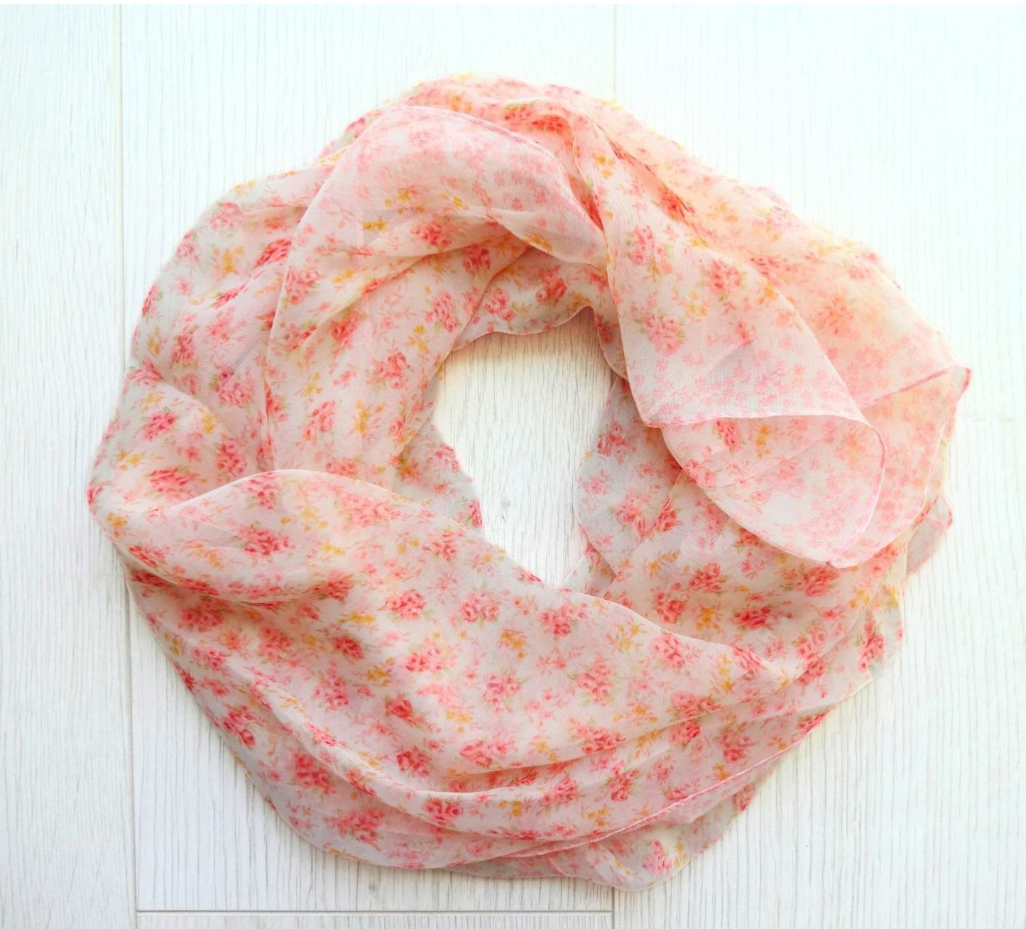 soft sheer chiffon flower scarf rolled in a circle