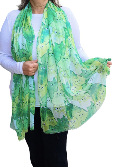 Green scarf with a charming all-over cat illustration pattern in various green and white tones. Soft, lightweight neckwear.