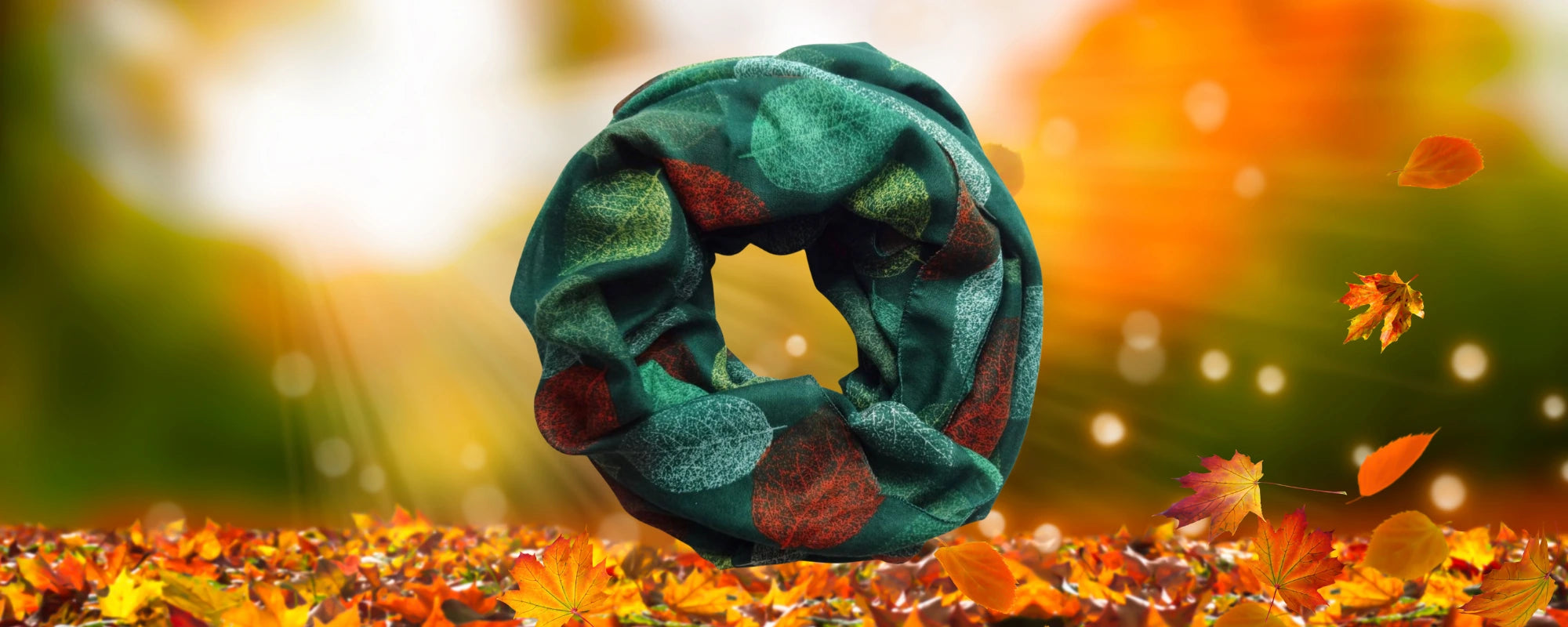 Green leaf print scarf with autumn leaves background – Aurora's Array seasonal homepage banner