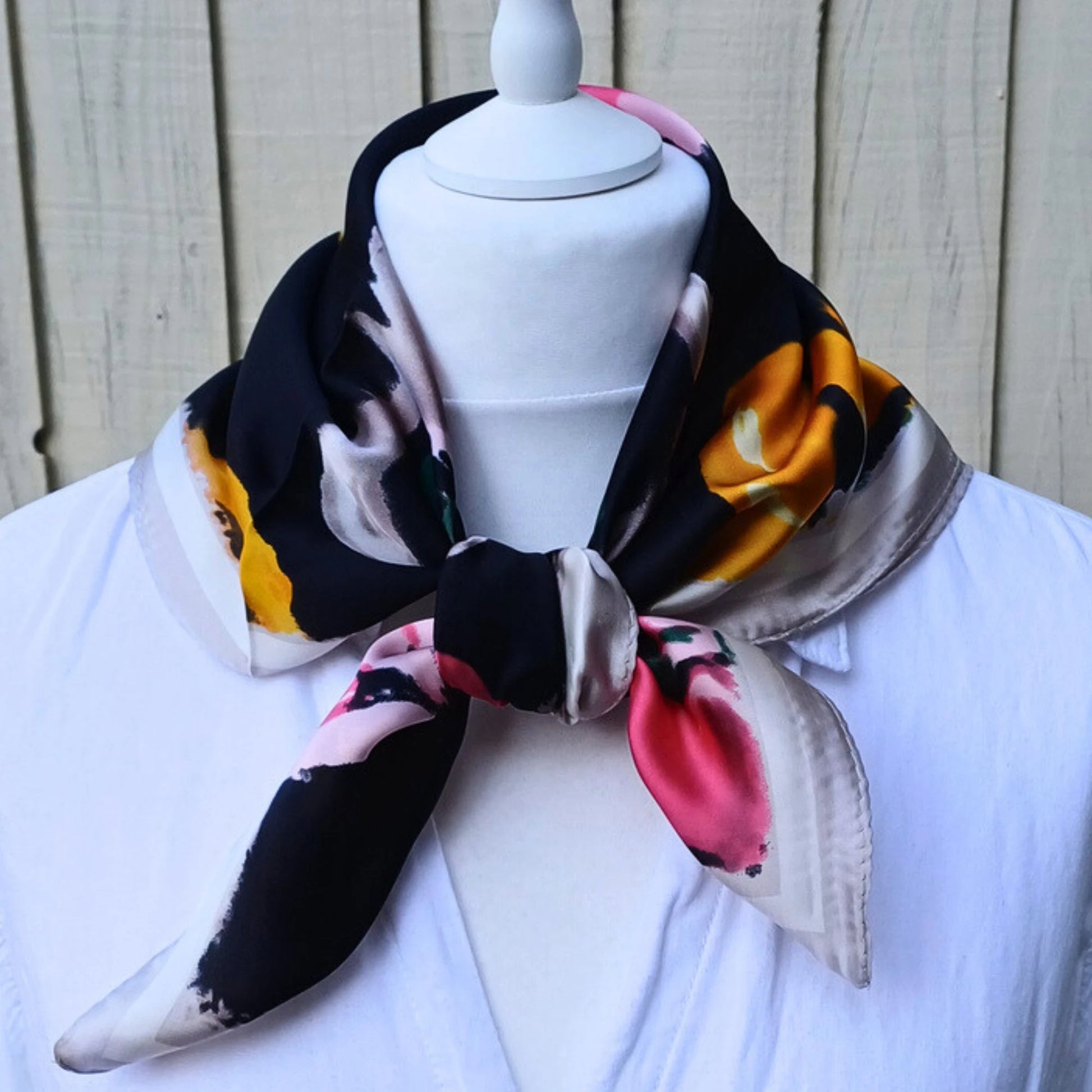Close up of black floral silky feel square scarf fabric pattern
