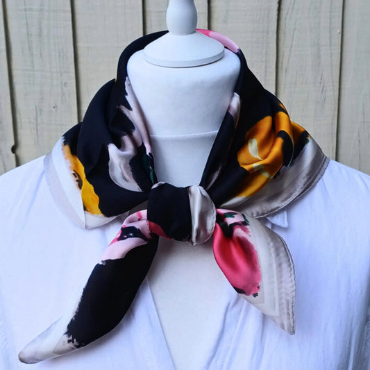 Close up of black floral silky feel square scarf fabric pattern