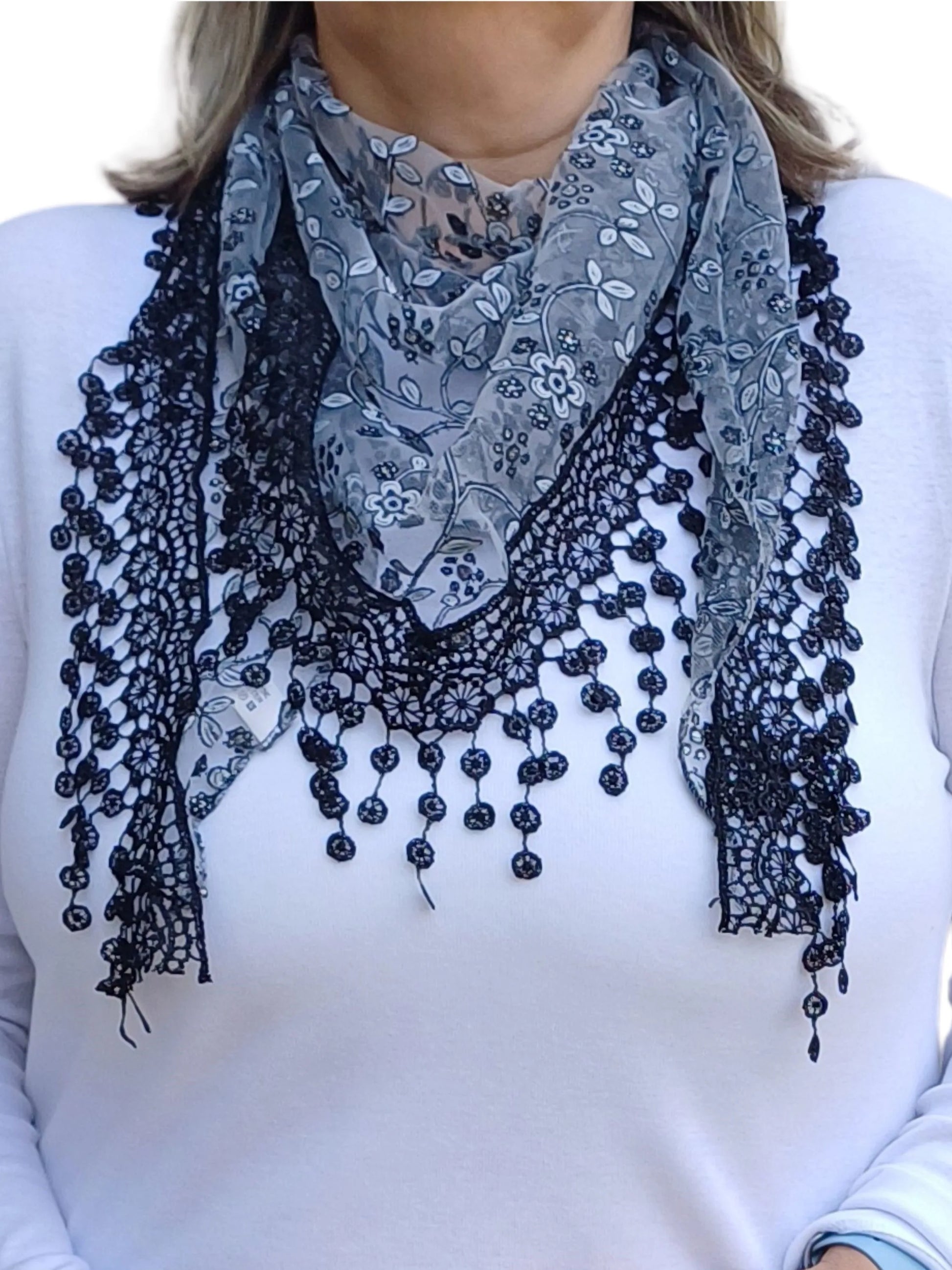 Auroras Array Glitter Triangle Scarf in black and grey with floral lace embroidery and delicate dangling lace trim styled in a soft triangular drape