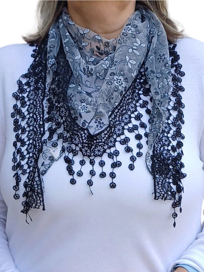 Auroras Array Glitter Triangle Scarf in black and grey with floral lace embroidery and delicate dangling lace trim styled in a soft triangular drape