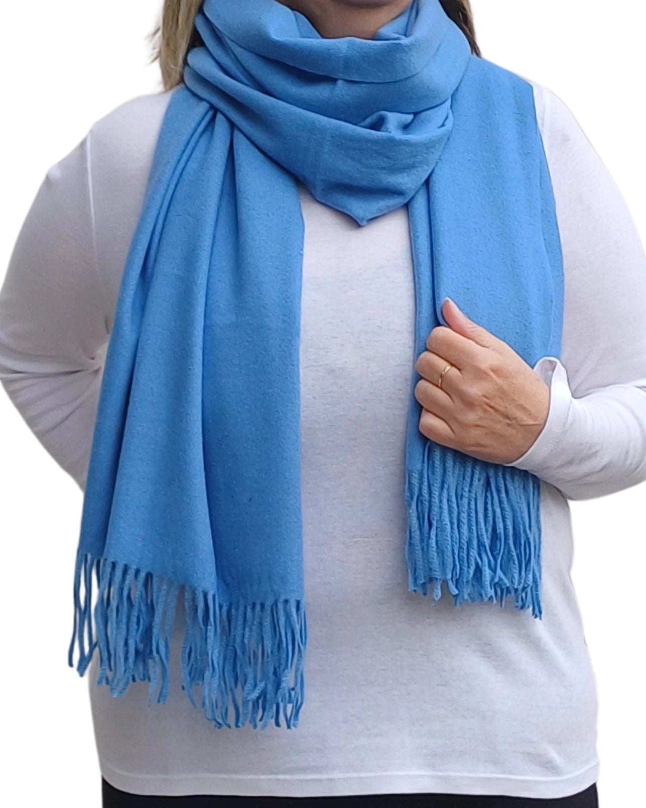 Person wearing a blue scarf with tassels on a white background