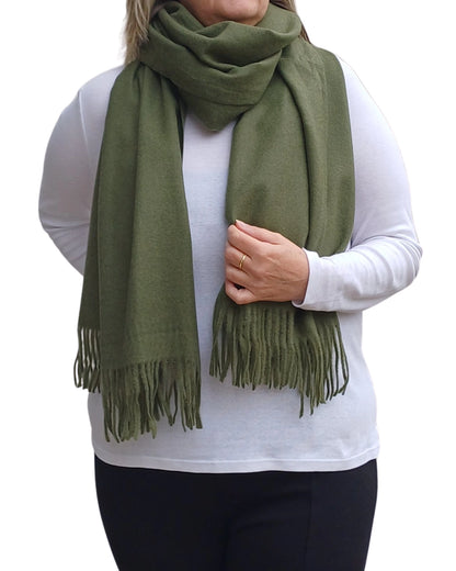 Dark green cashmere blend winter scarf styled as a wrap, soft plain medium weight fabric, perfect for layering