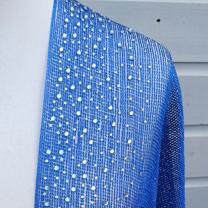 Cobalt blue sparkly kimono fabric with rhinestones and metallic lace texture shown close up
