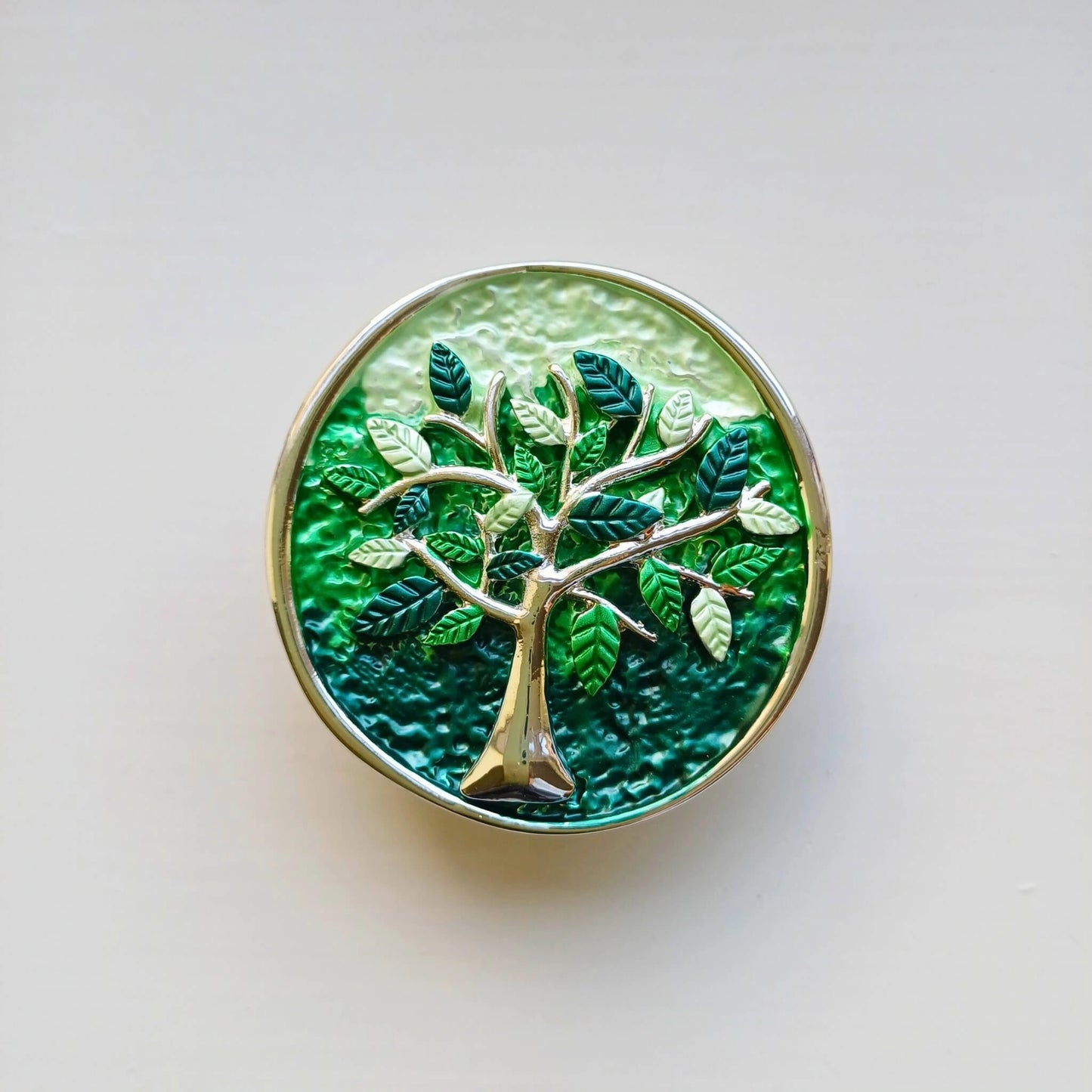 colourful tree of life magnetic brooch green on wooden background