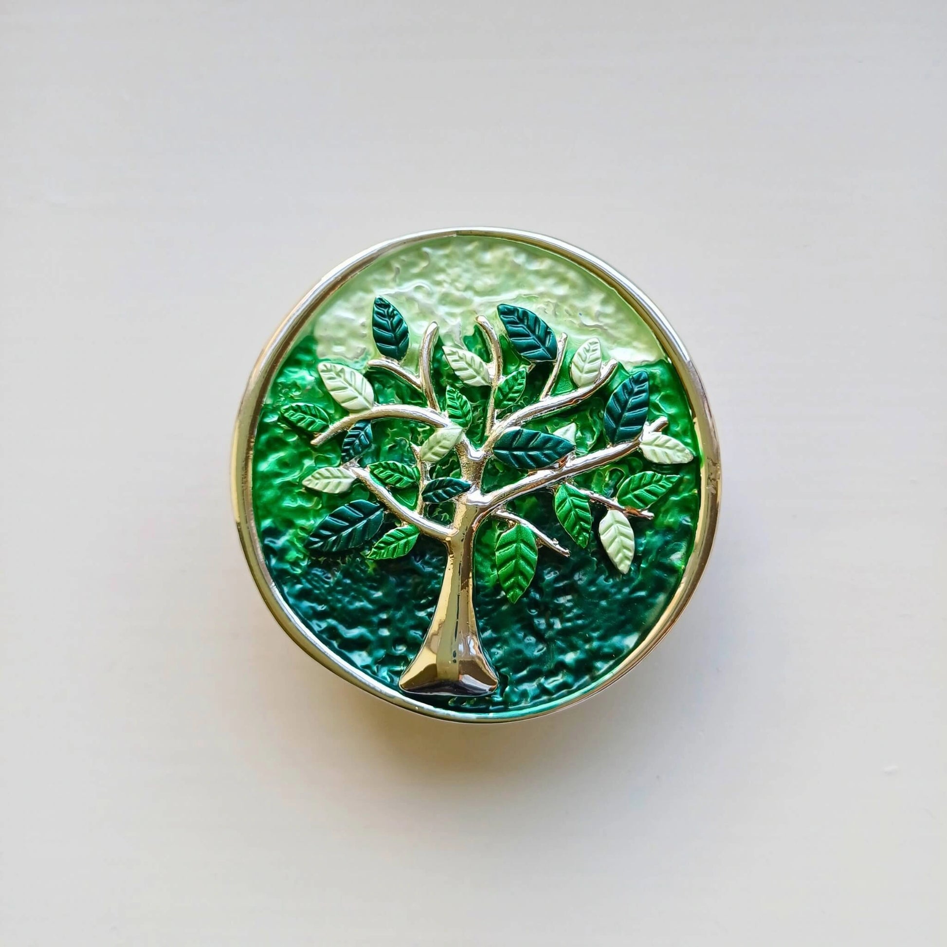 colourful tree of life magnetic brooch green on wooden background
