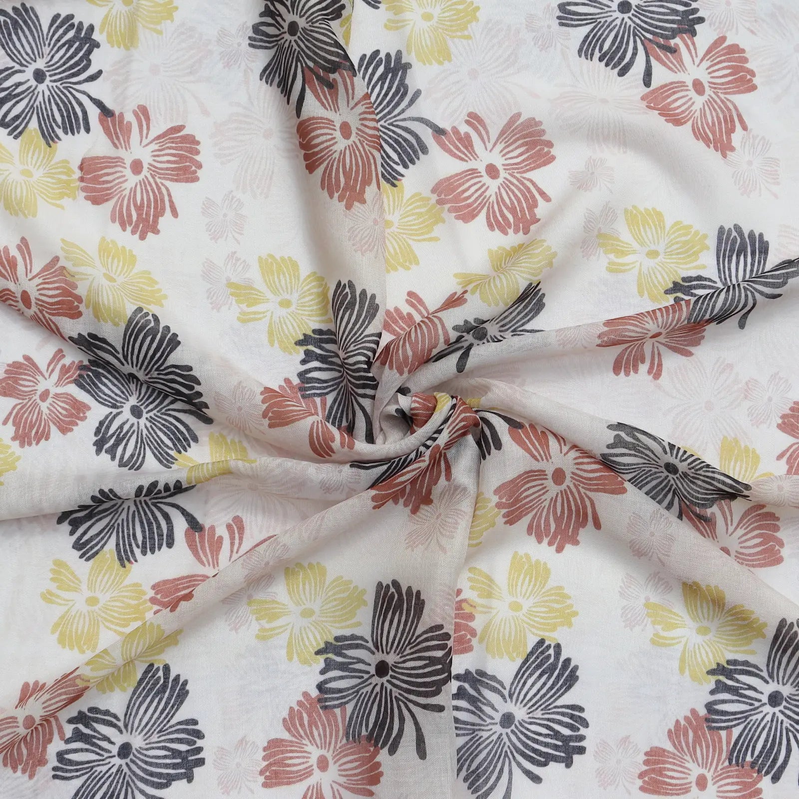 Lightweight cream scarf with floral print in black red and yellow swirled to show texture