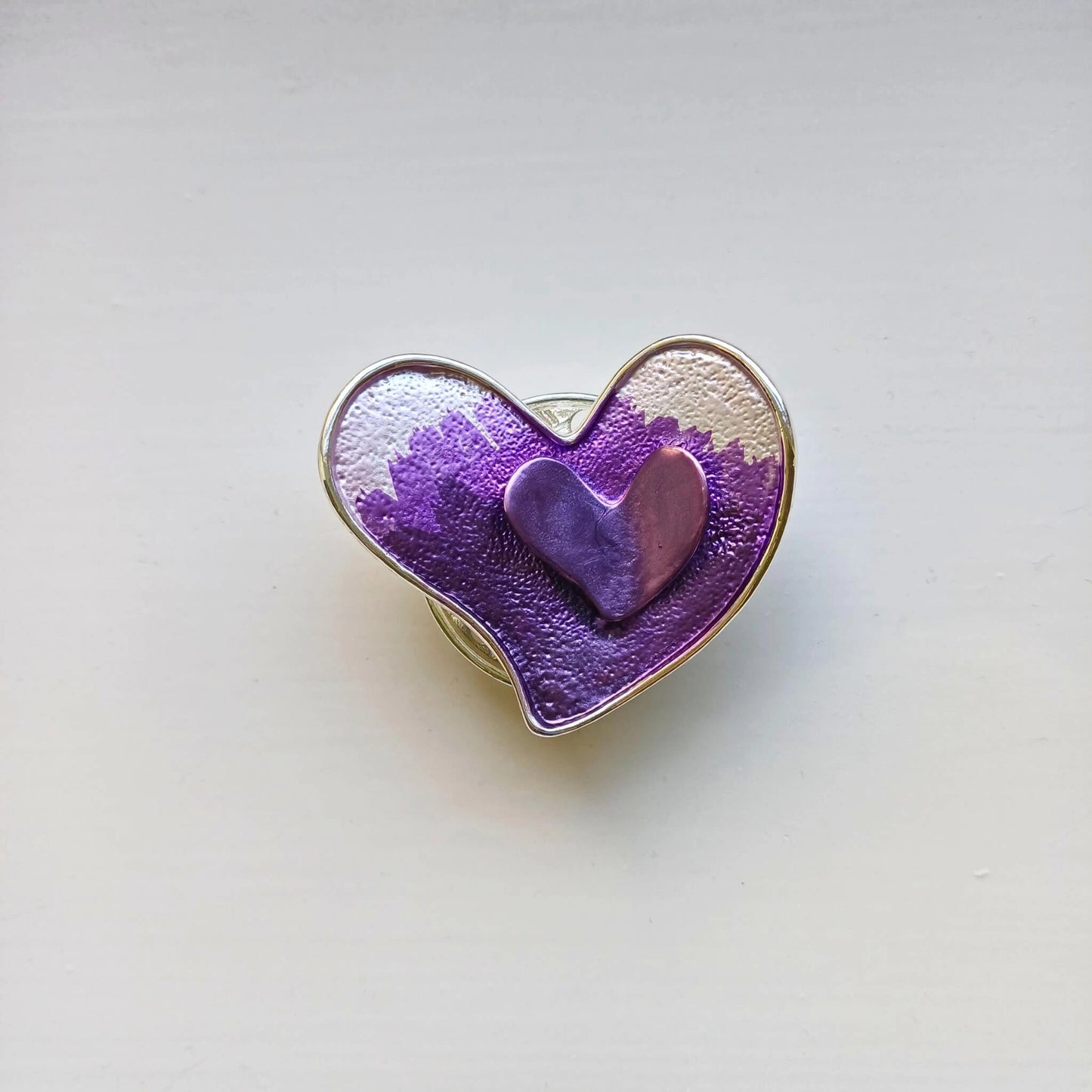 double heart magnetic brooch purple on wooden background