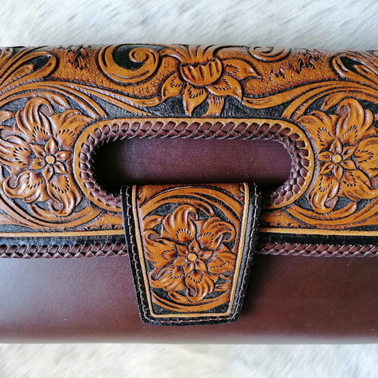 Close-up of floral tooling on leather flap and handle slot – Elegancia bag