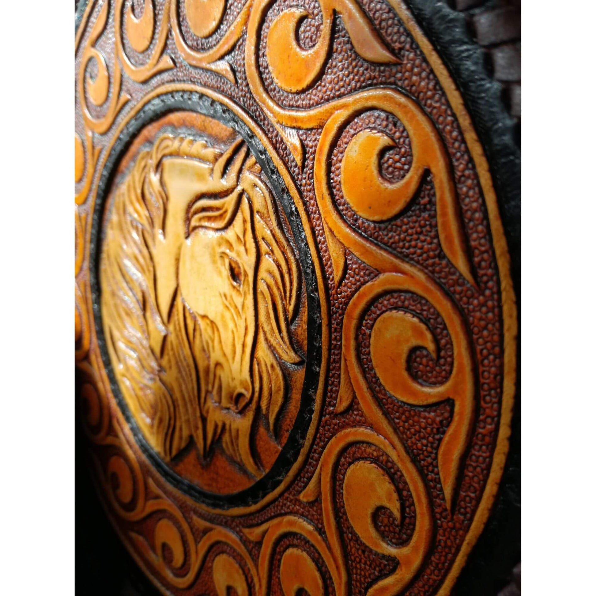 Close-up of horse and scrollwork tooling on vegetable tanned leather bag