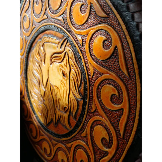 Close-up of horse and scrollwork tooling on vegetable tanned leather bag